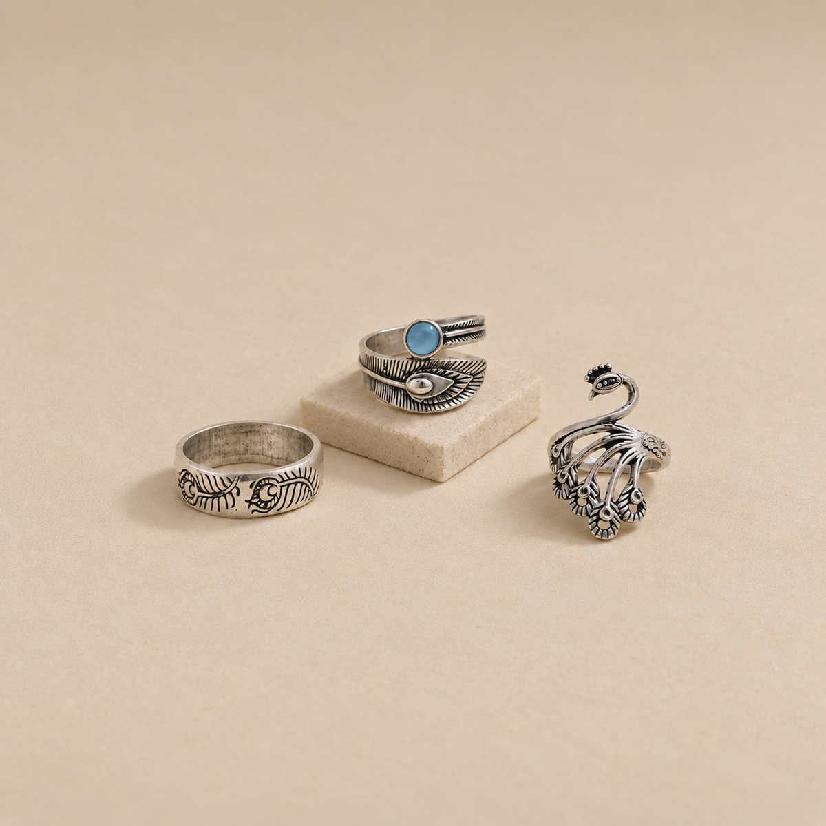 Three oxidised metal statement rings arranged as a 3-piece imitation ring set