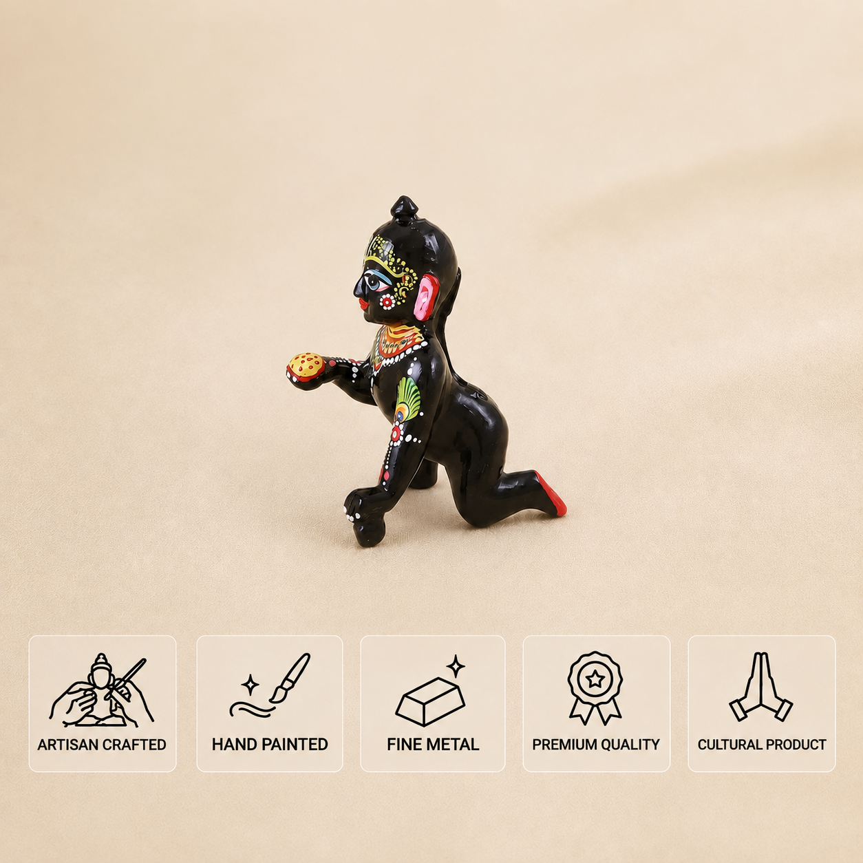 Side view of a hand-painted black Laddu Gopal idol holding a laddu.