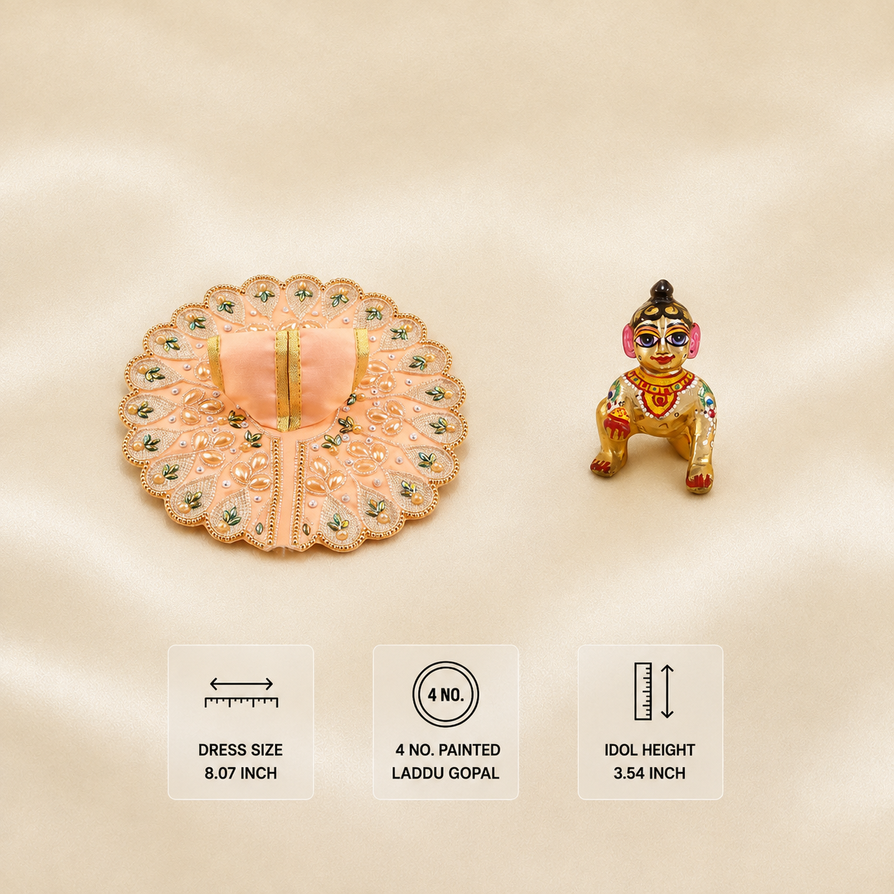 Peach embroidered Laddu Gopal dress with matching painted idol, pearl details, green leaf motifs and gold border