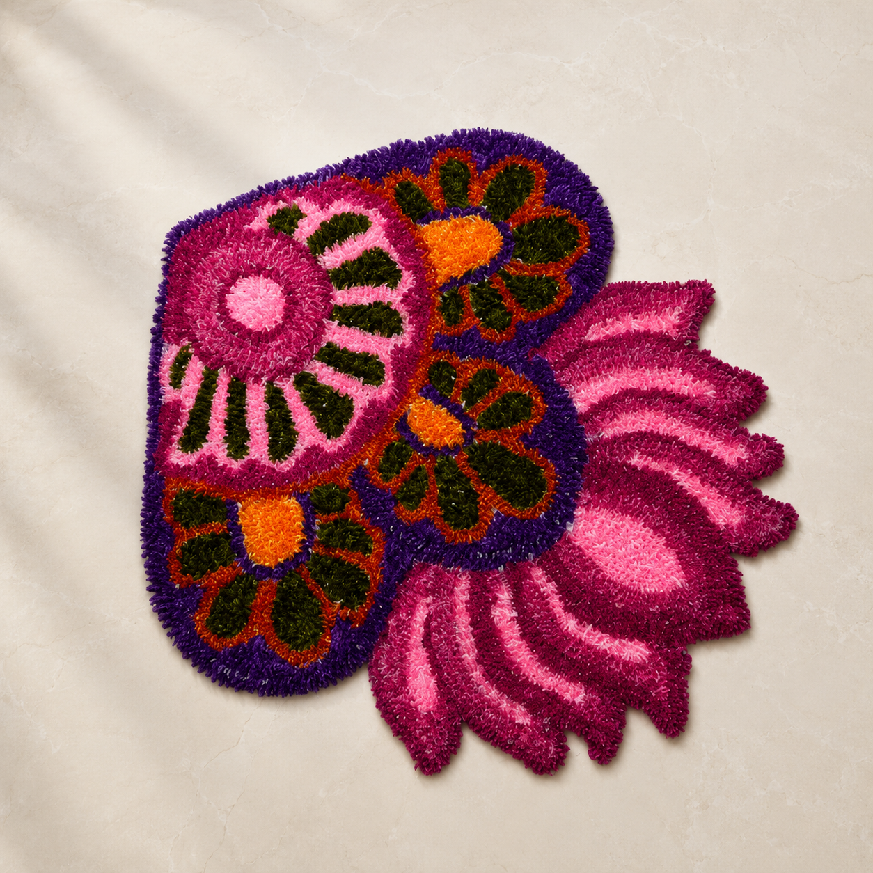 Pink and purple lotus corner woolen rangoli with orange and green detailing for floor decoration