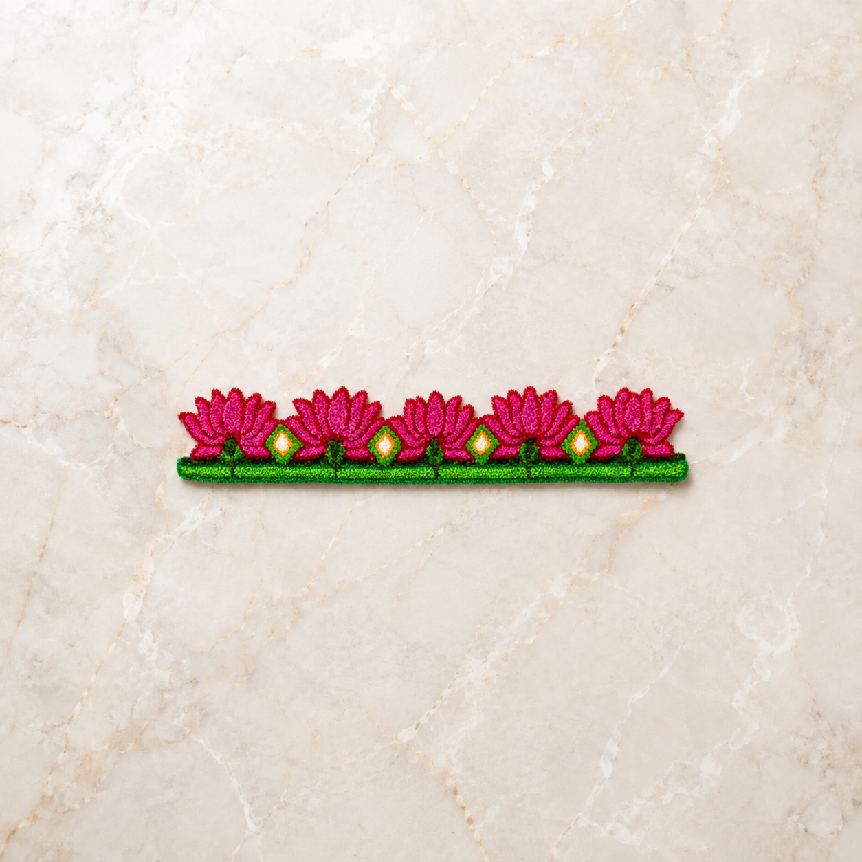 Pink lotus floral rangoli border with green base and diamond motifs