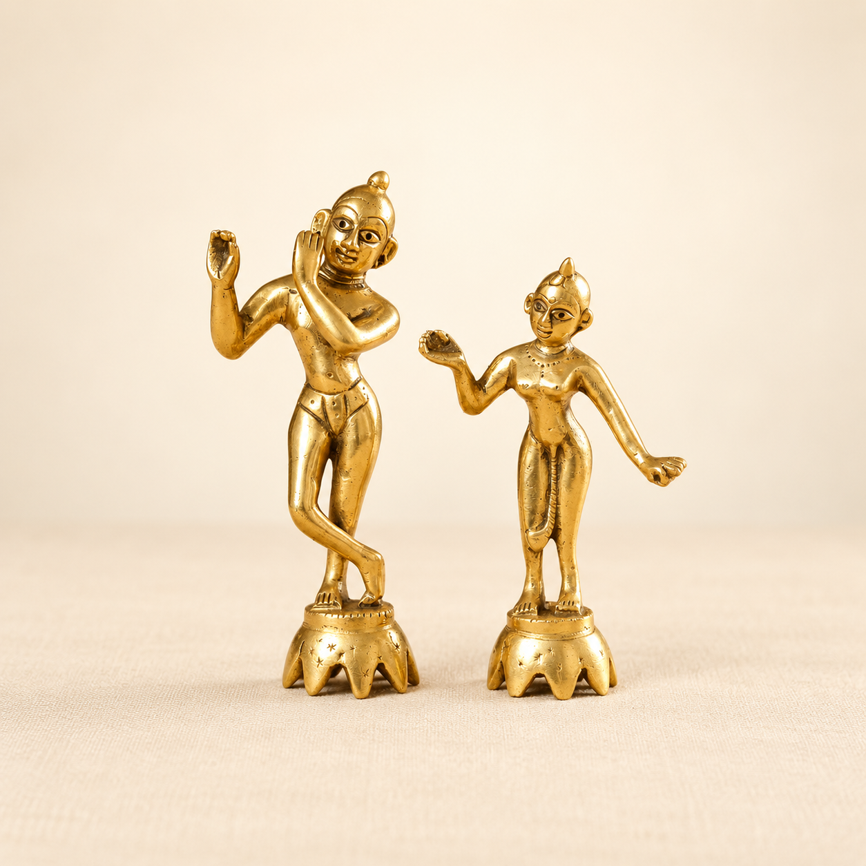 Plain golden Radha Krishna idol pair with traditional metal finish.