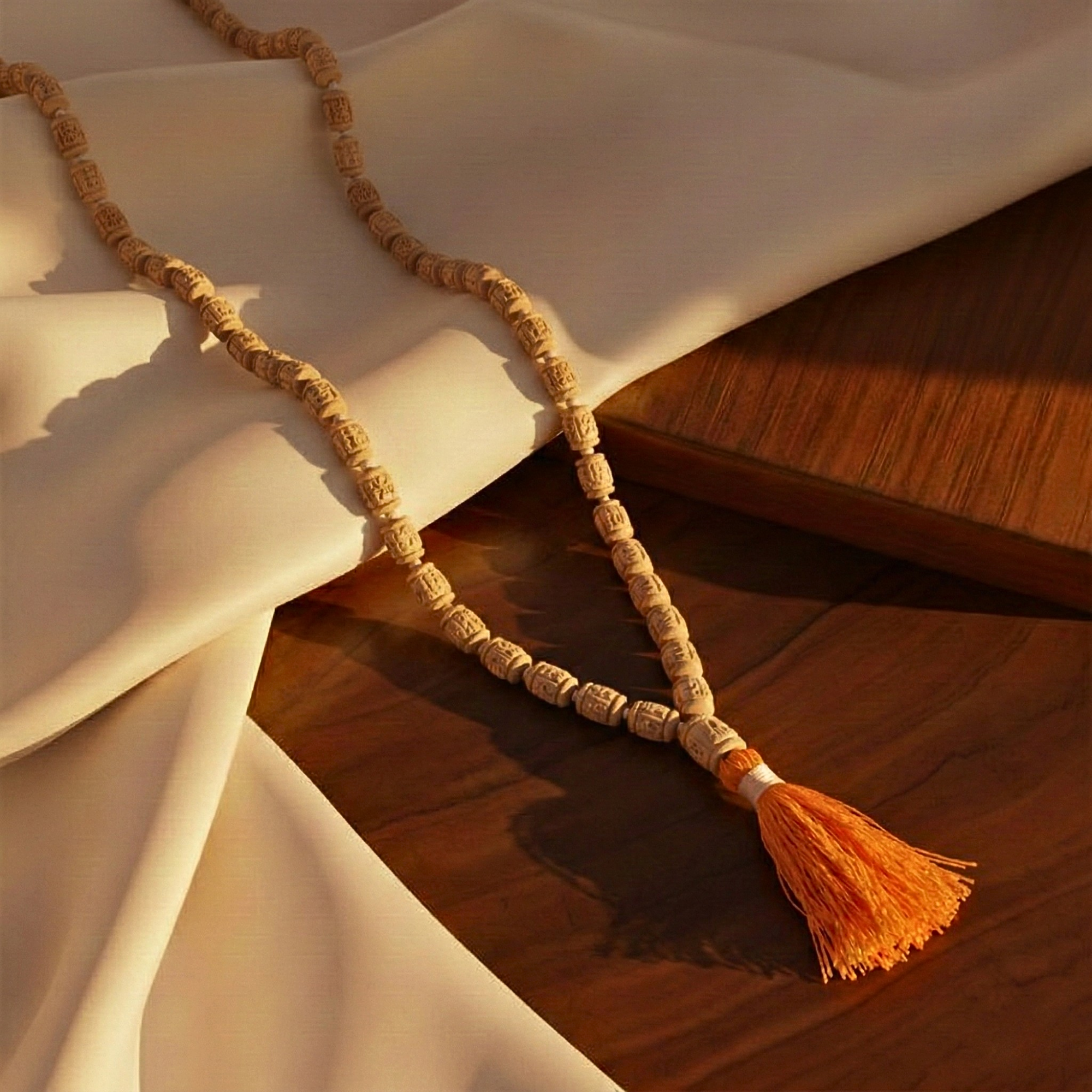 Premium original Tulsi japa mala featuring 108 hand carved wooden beads and an orange tassel