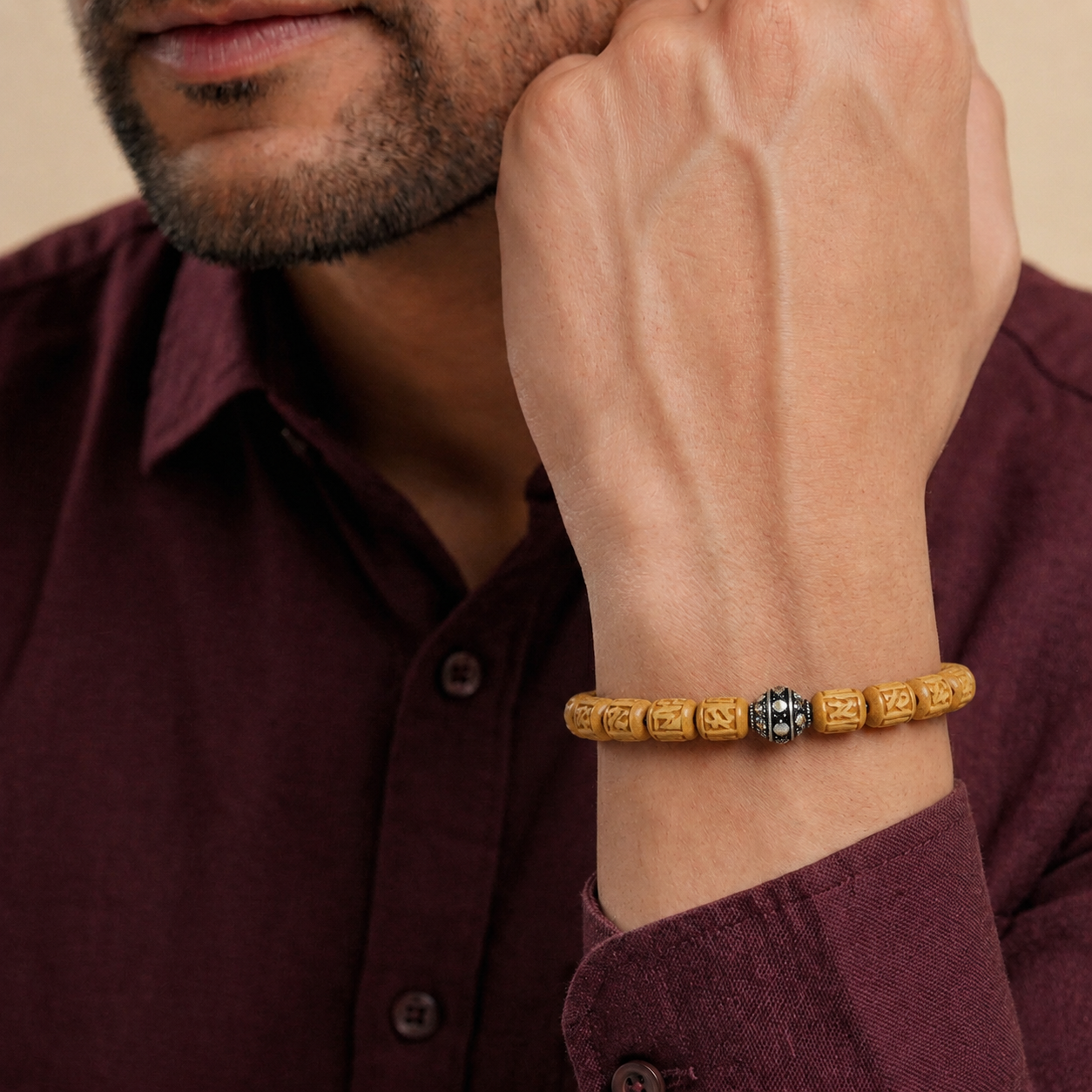 Man wearing a pure silver bracelet featuring authentic Tulsi wood beads on his wrist