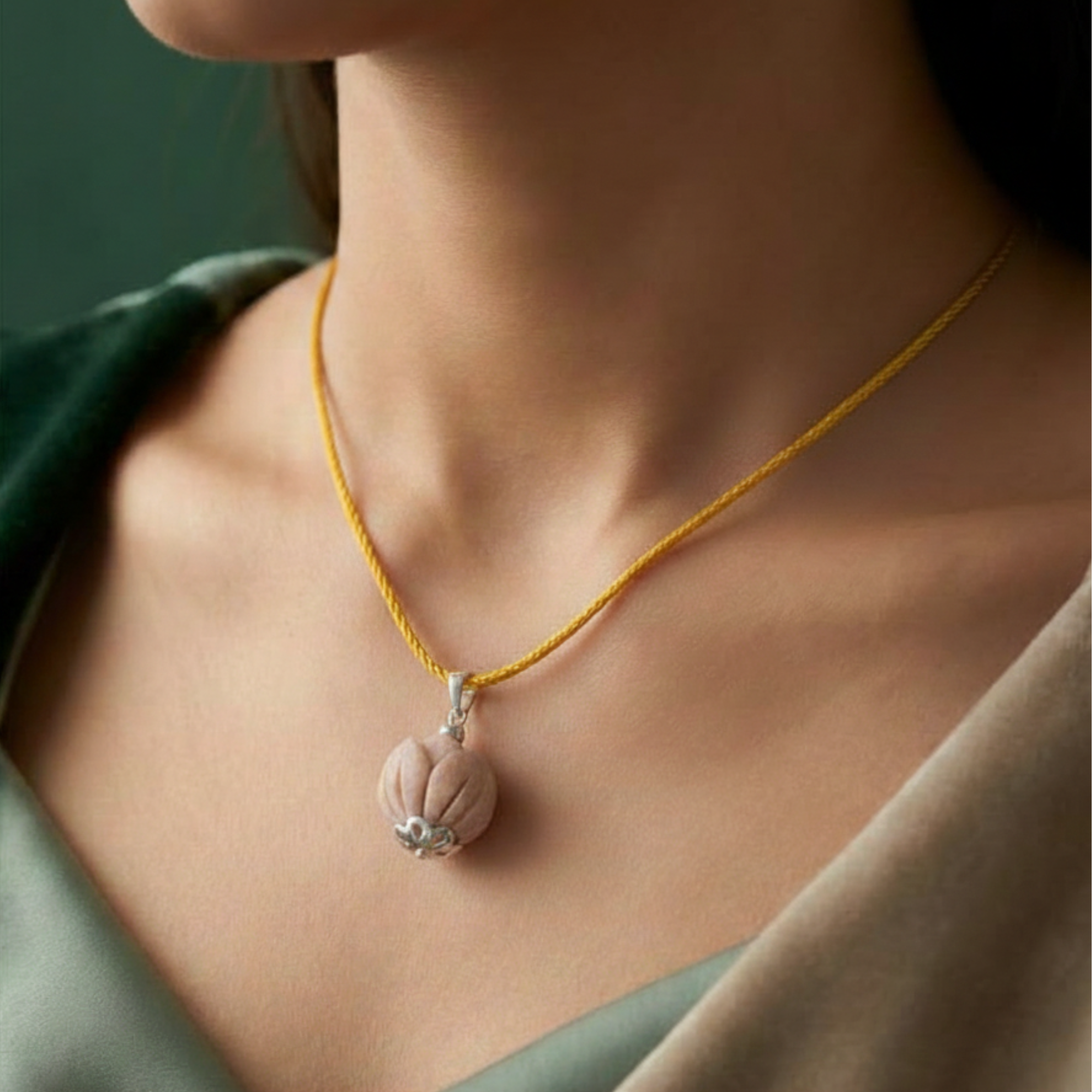 Person wearing a pure silver pendant featuring a sacred Tulsi wood bead in a lotus design