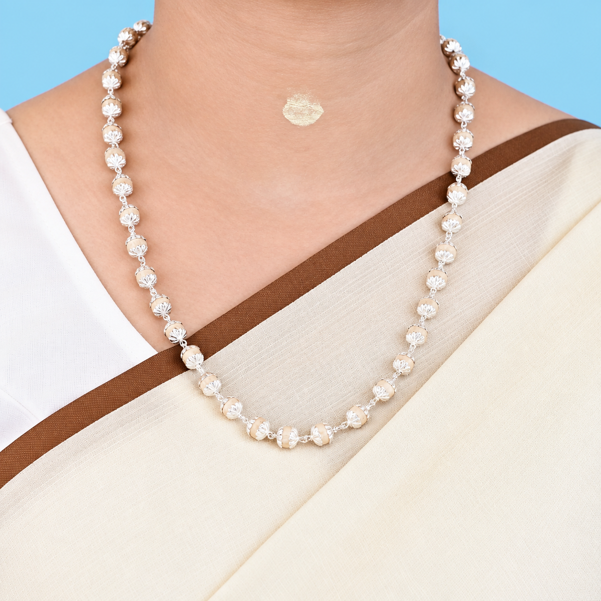 Woman wearing pure silver Tulsi Mala with original natural Tulsi beads in a traditional necklace style