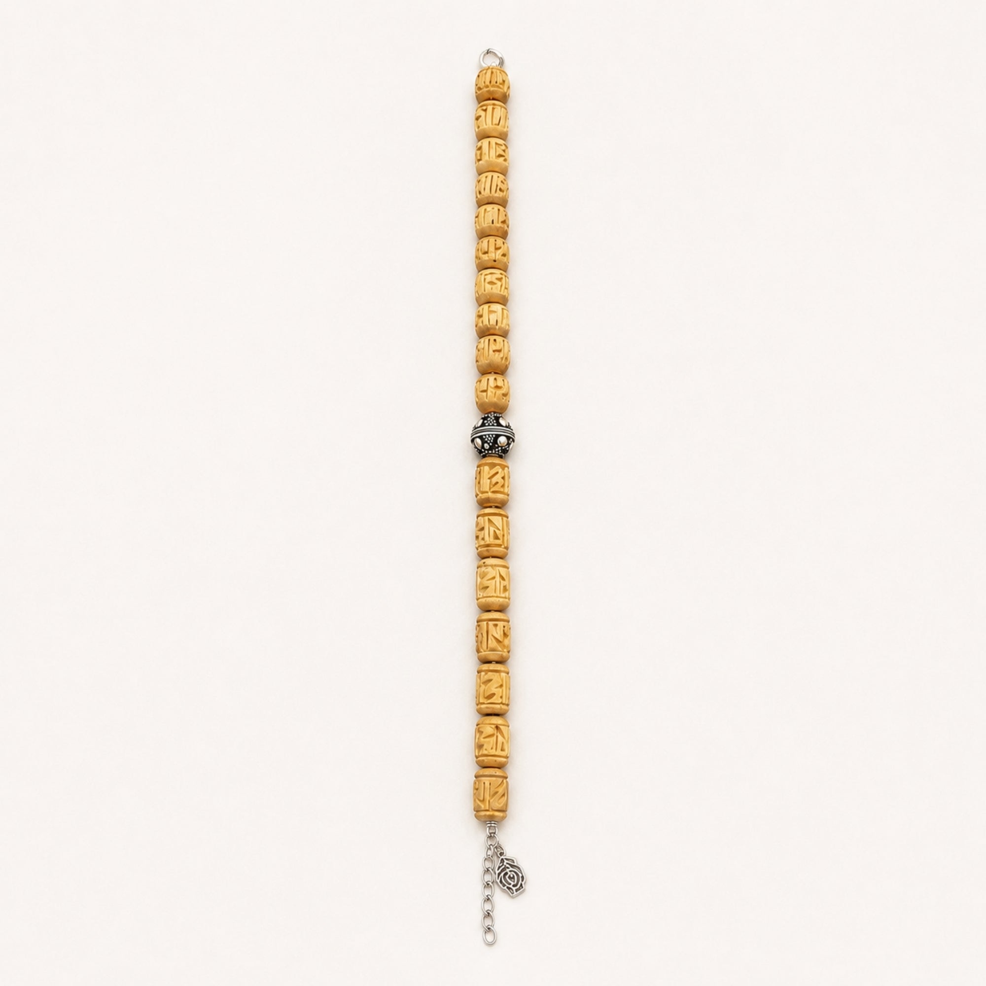 Close up flat lay of a pure silver bracelet featuring authentic Tulsi wood beads