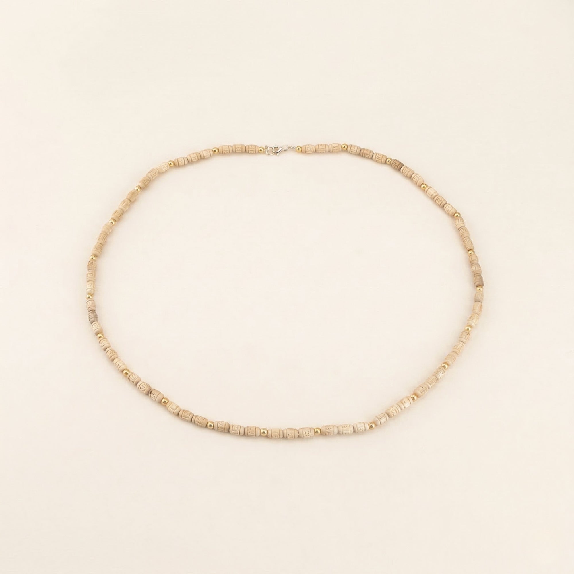 Close up flat lay of an authentic pure Tulsi beads necklace with gold accents