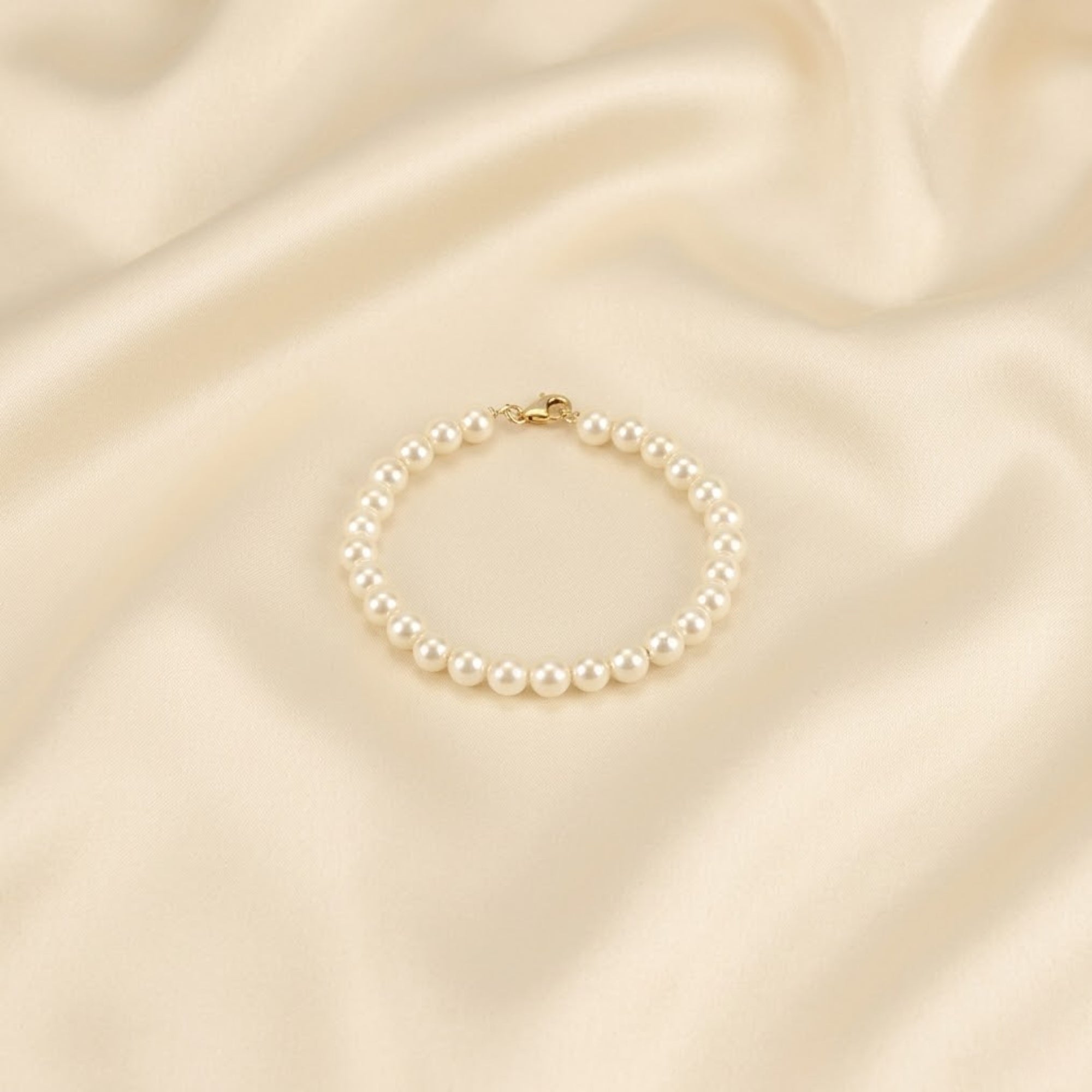 Pure 925 silver natural white pearl strand bracelet with silver hook clasp displayed on cream silk