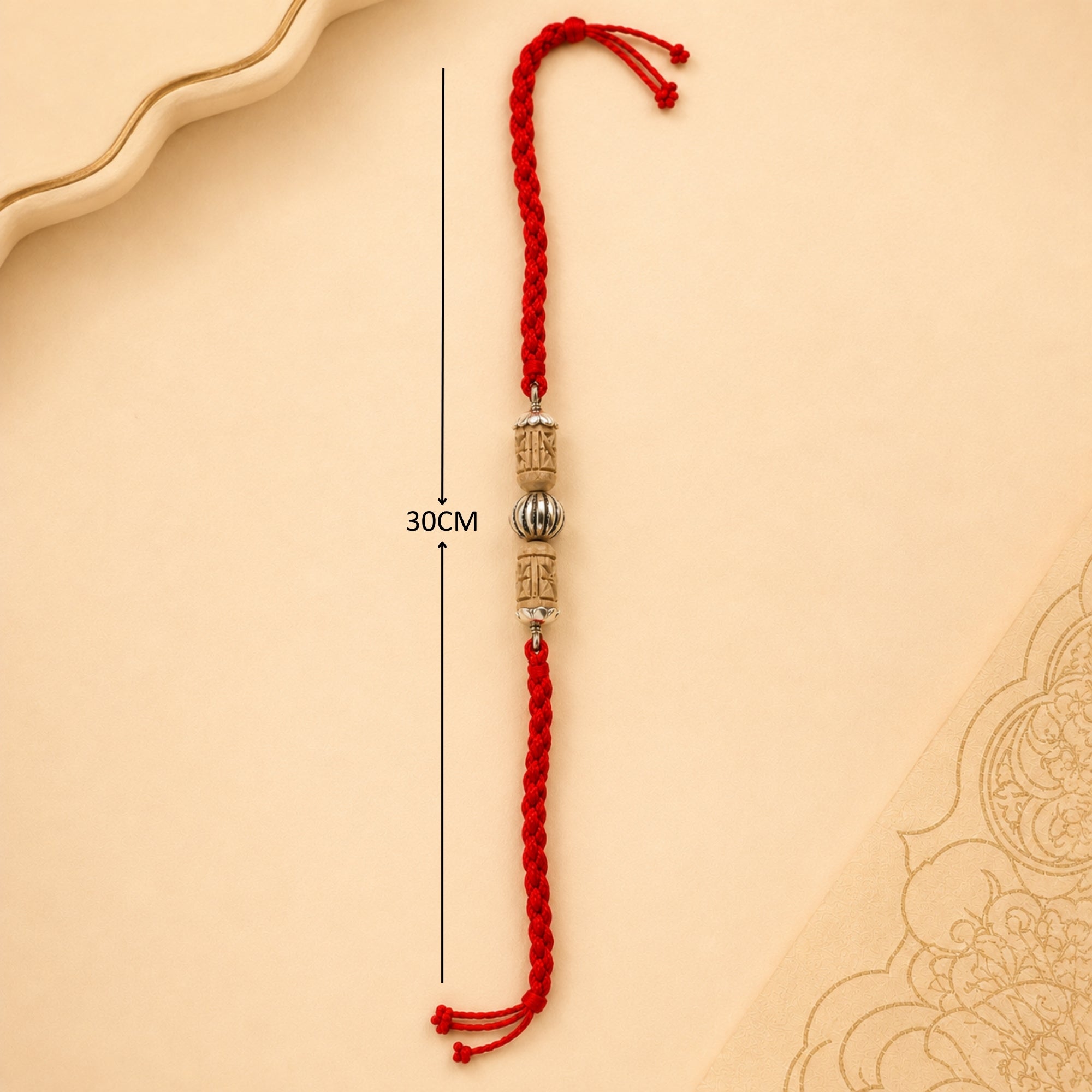 Full length layout showing red thread length and dimensions of pure silver carved floral Tulsi bead rakhi