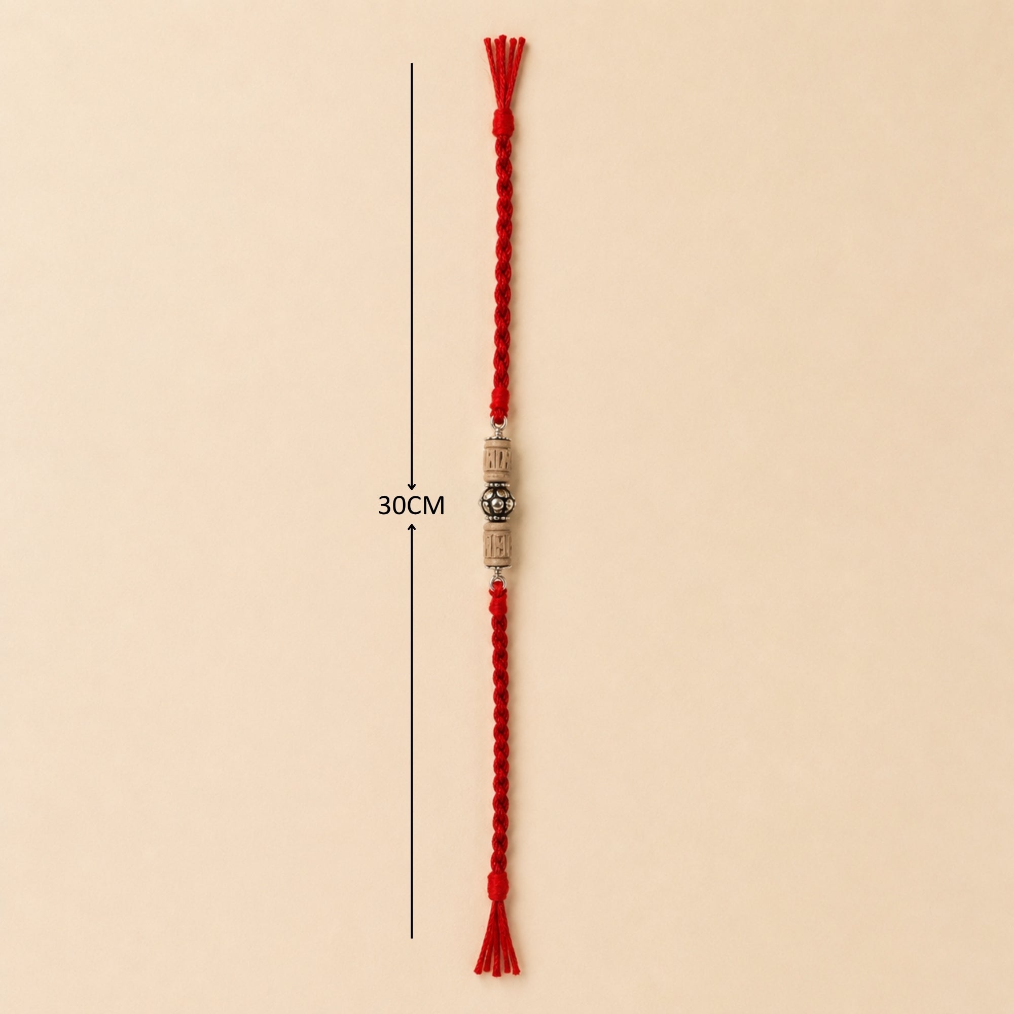Full length layout showing red thread length and dimensions of pure silver carved Tulsi bead rakhi