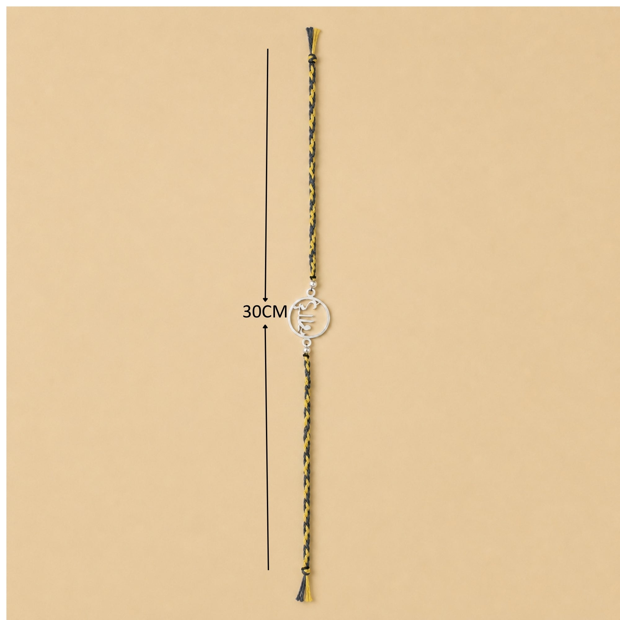 Full length view showing thread layout and tassels of pure silver circular Bhai calligraphy rakhi