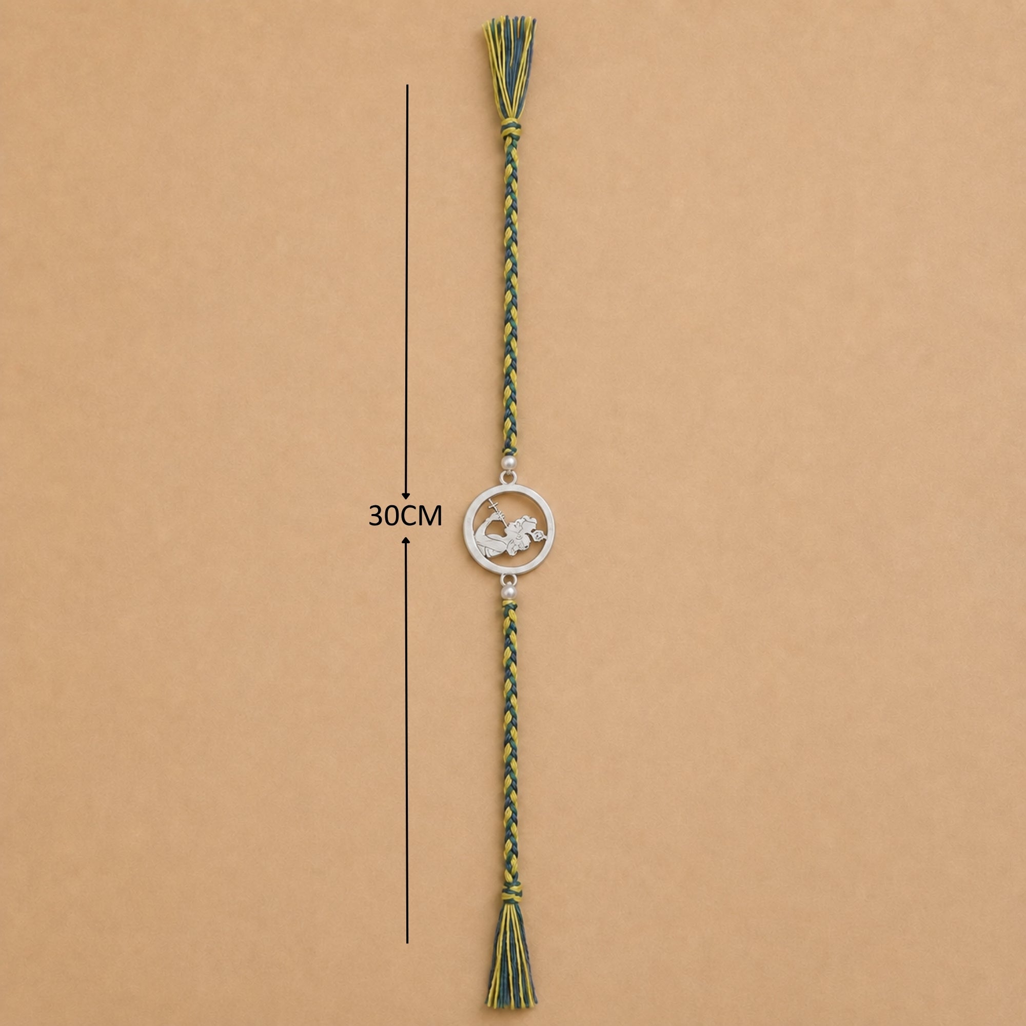 Full length view showing thread layout and tassels of pure silver Krishna flute rakhi