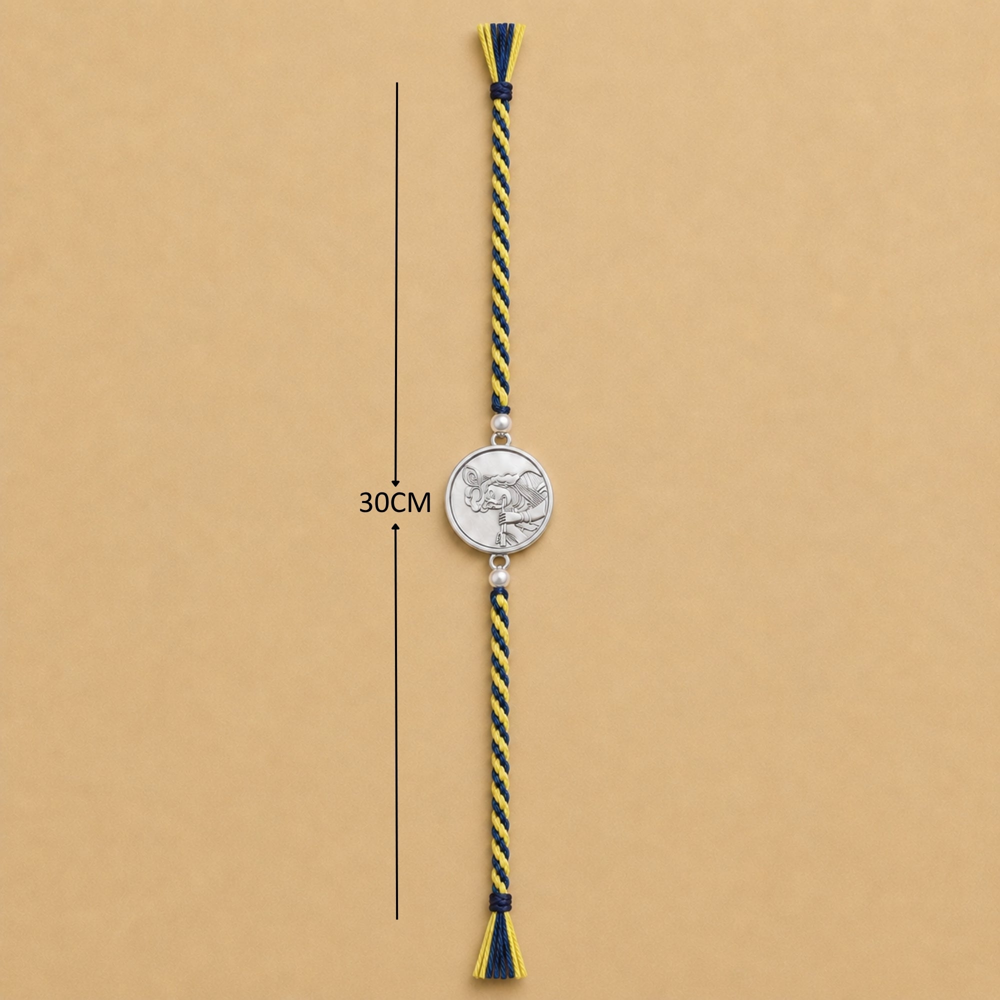 Full length view showing thread layout and tassels of pure silver Lord Krishna portrait coin rakhi
