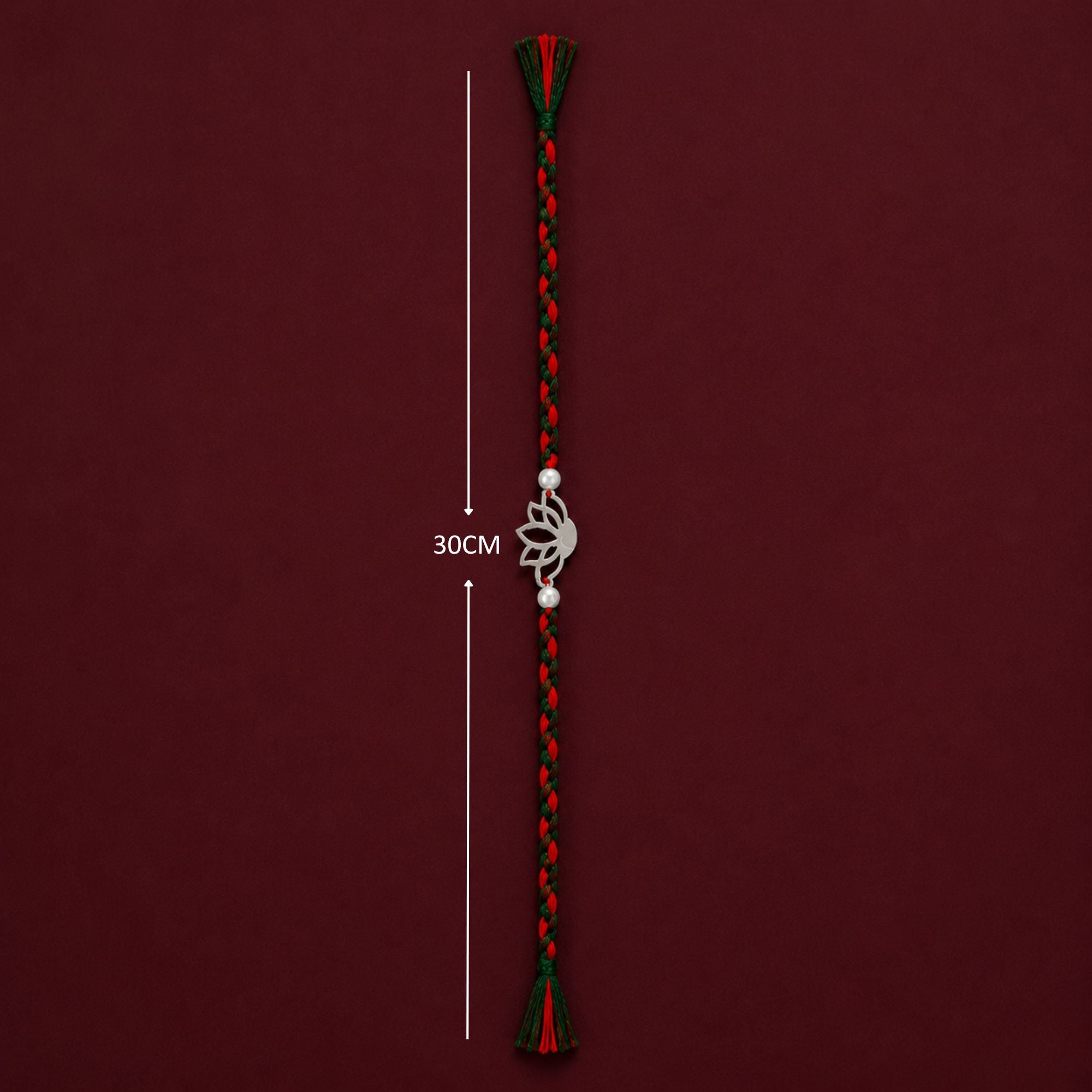 Full length 30cm red and green braided thread layout of silver lotus rakhi
