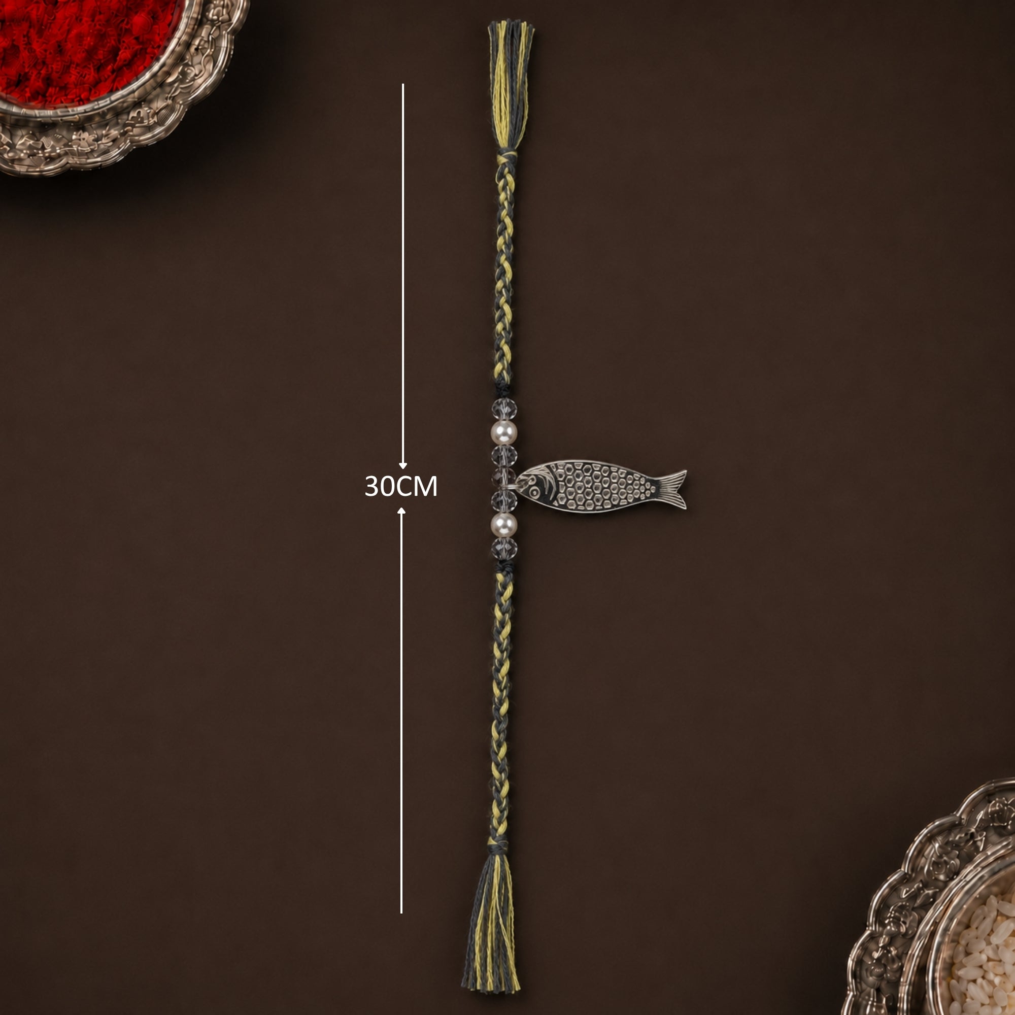Full length view showing thread layout and tassels of pure silver Matsya fish rakhi