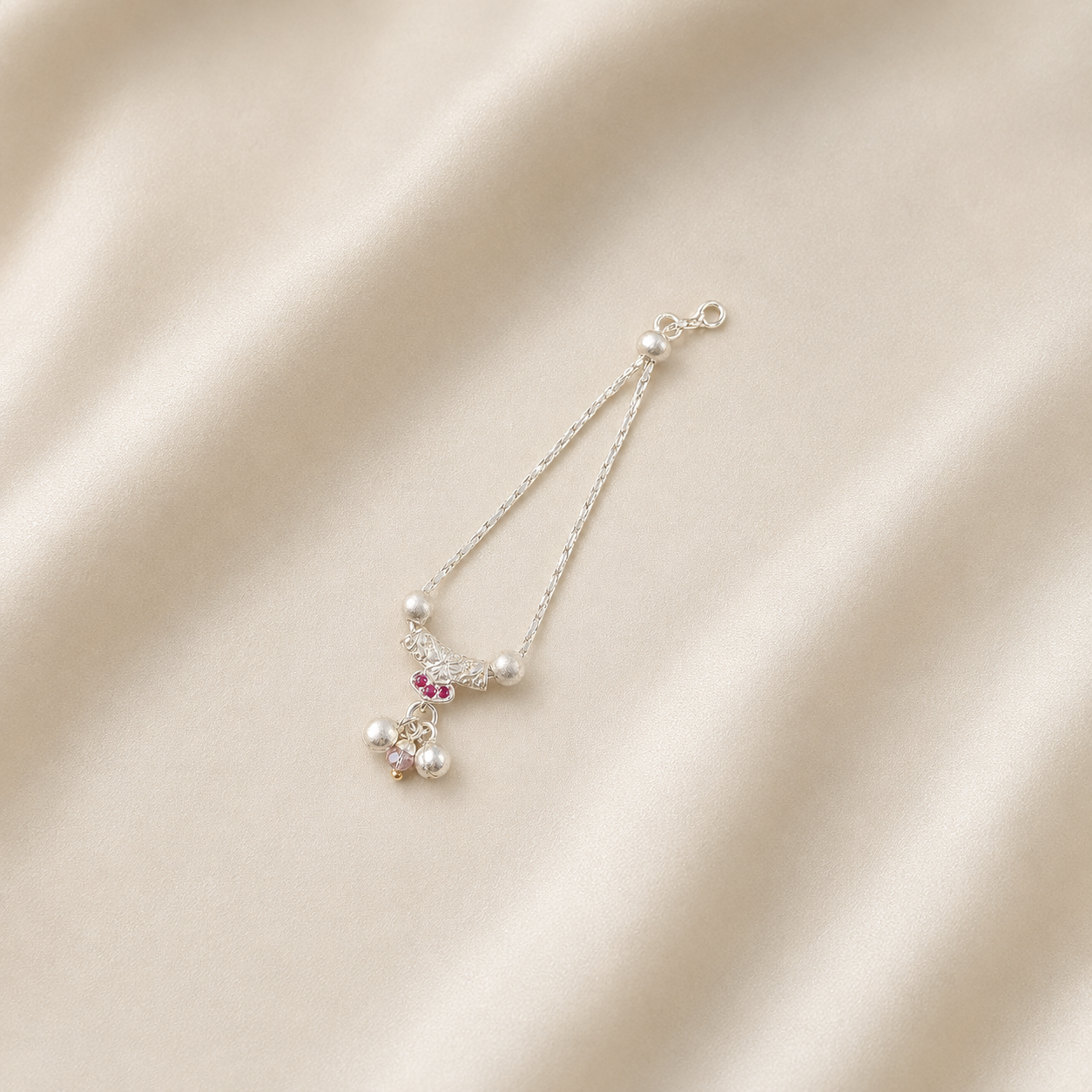 Pure silver necklace for deity idols with pink stones and pearl drops on cream silk fabric