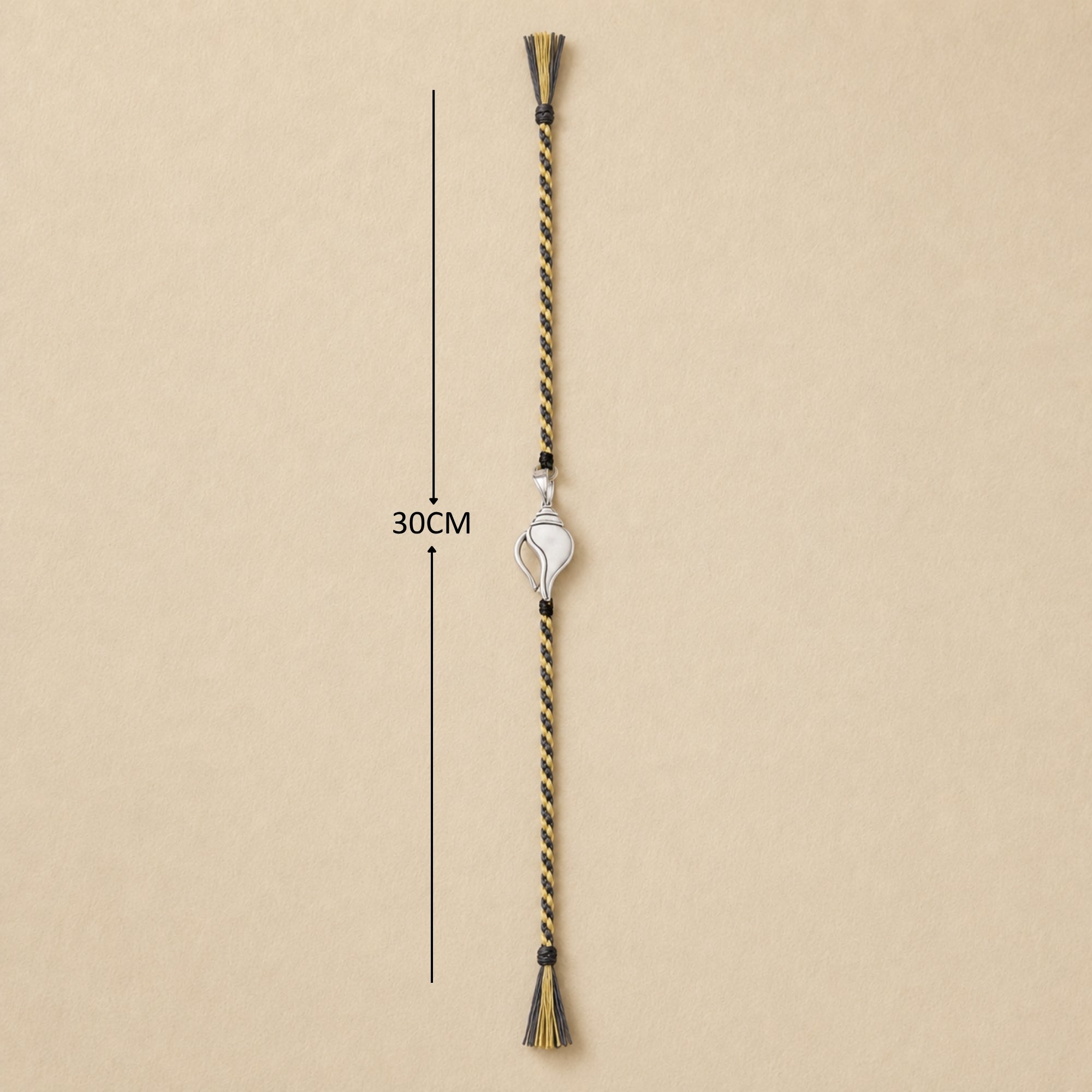 Full length view showing thread layout and tassels of pure silver Shankh rakhi