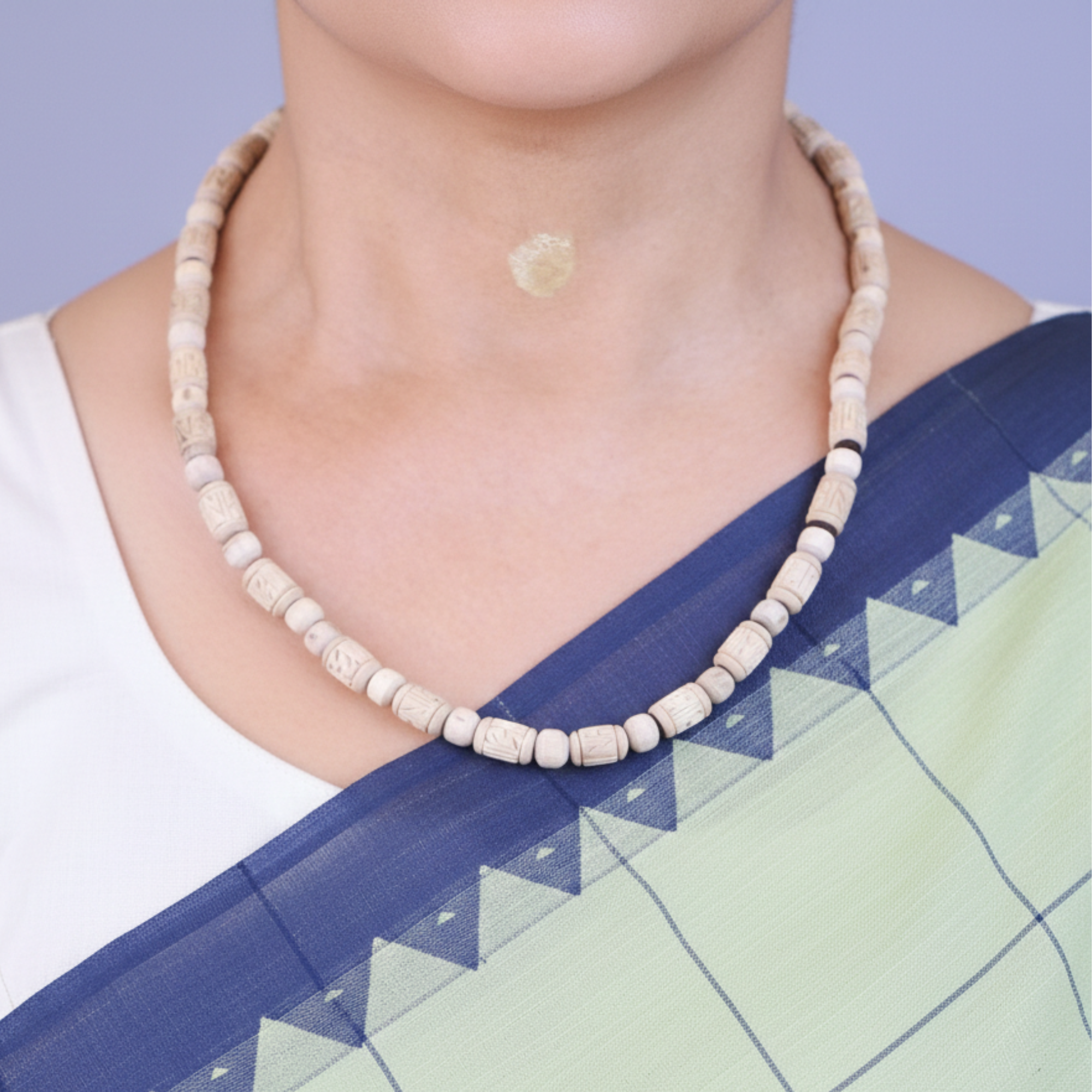 Woman wearing a natural finish Tulsi kanthi mala with Radha name carved beads