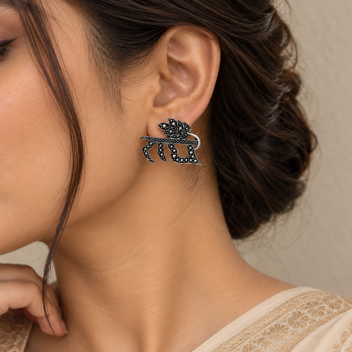 Radhe oxidized metal earrings with intricate leaf design worn by a woman