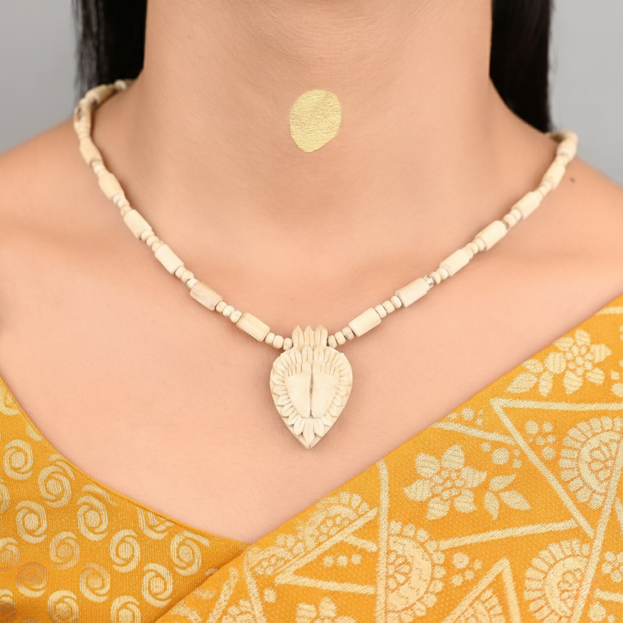 Woman wearing a pure Tulsi kanthi mala with an intricately carved Shree Radha Charan pendant