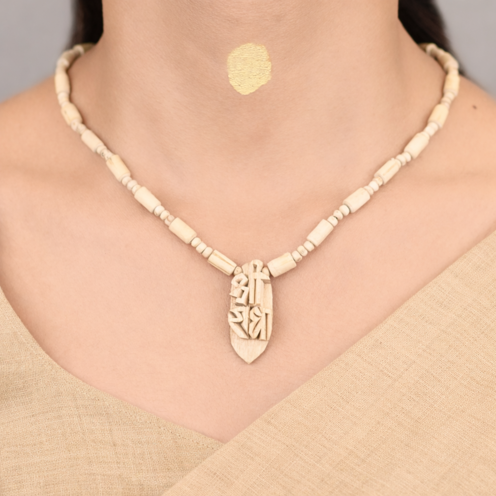 Woman wearing a pure Tulsi kanthi mala with an intricately carved Shree Radha pendant