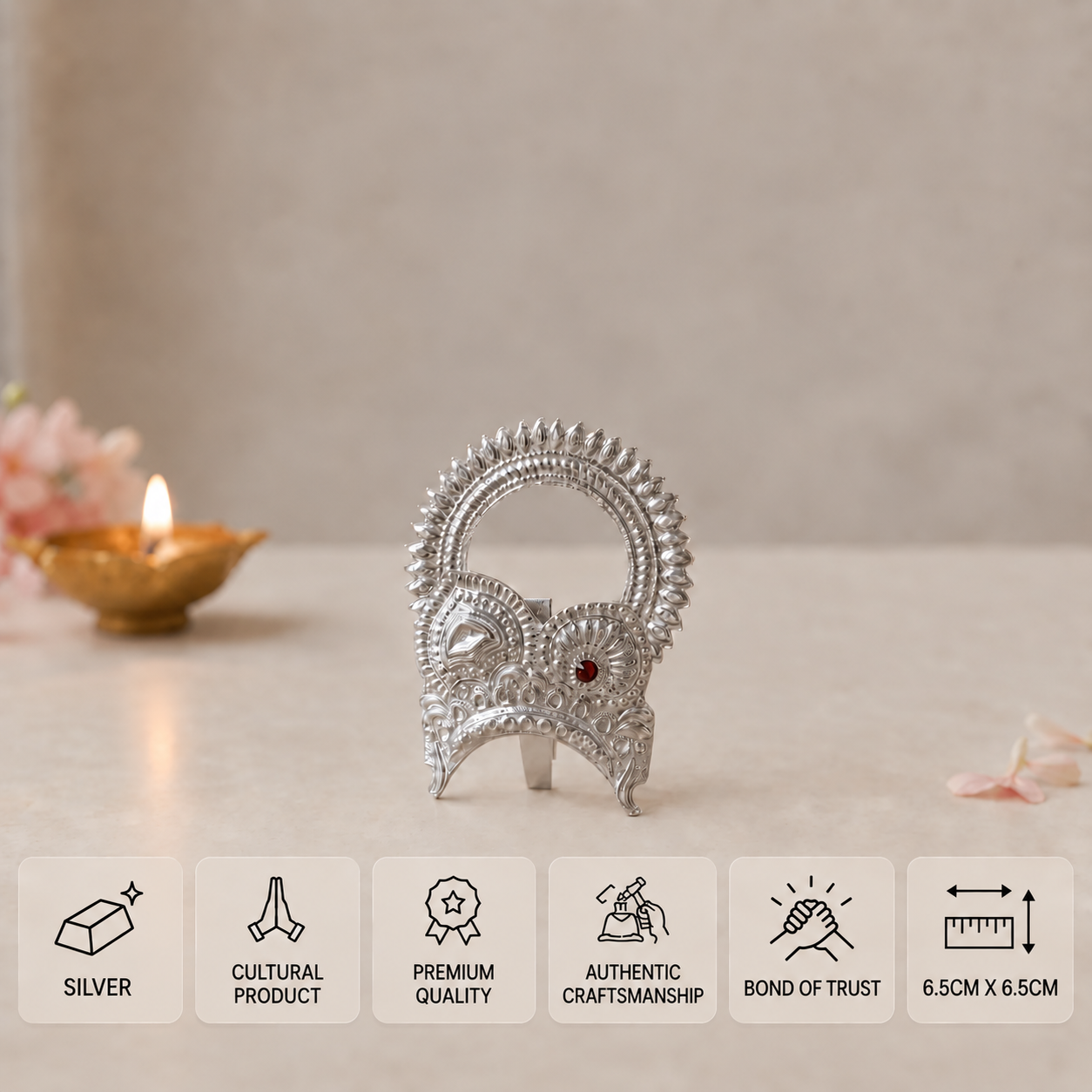 Embossed silver idol crown with an arched design and central red stone, measuring 6.5 × 6.5 cm.