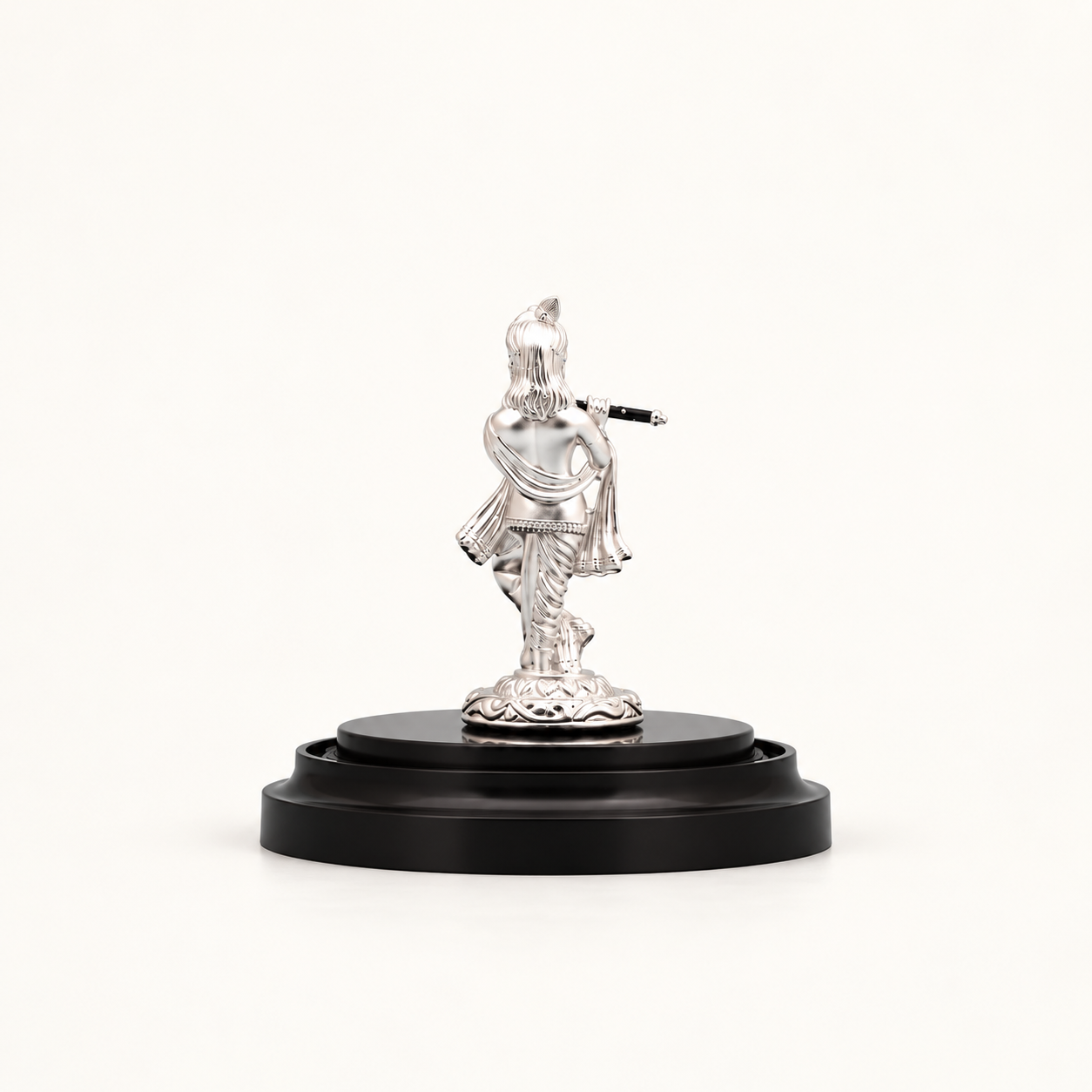 Back view of a silver Lord Krishna idol playing a flute, mounted on a round black wooden pedestal base.