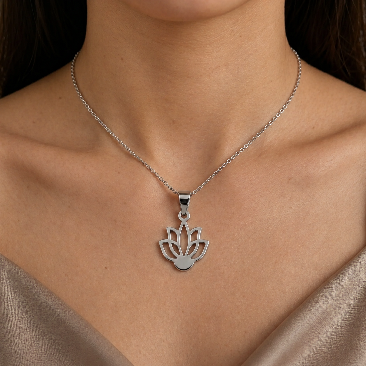 Close-up of a woman wearing a silver lotus flower pendant necklace 