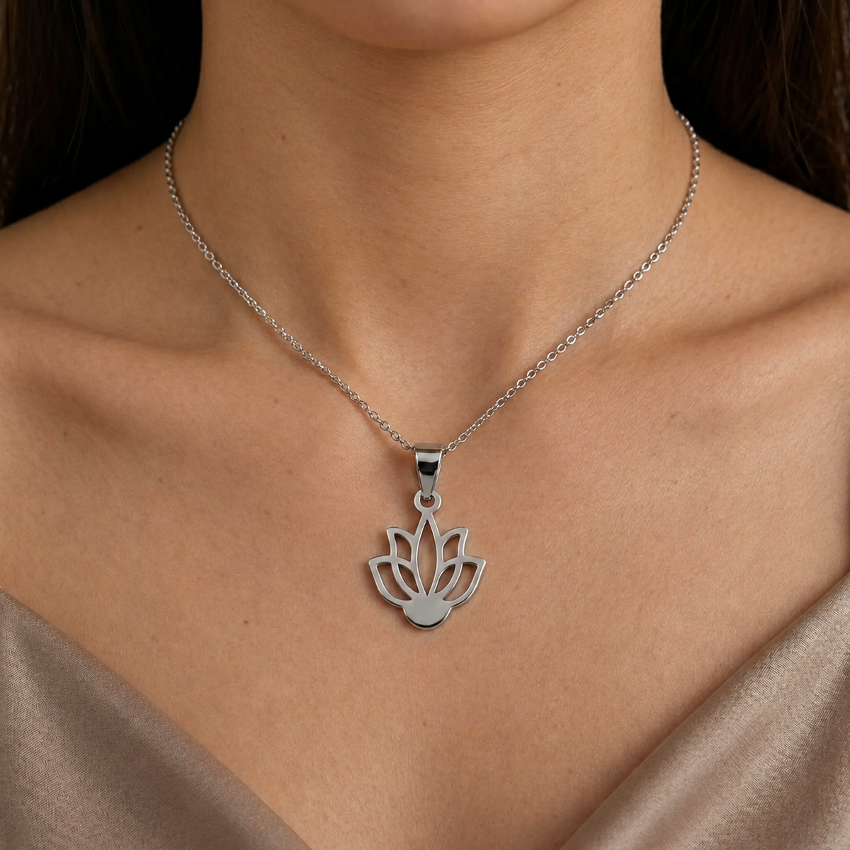 Close-up of a woman wearing a silver lotus flower pendant necklace 