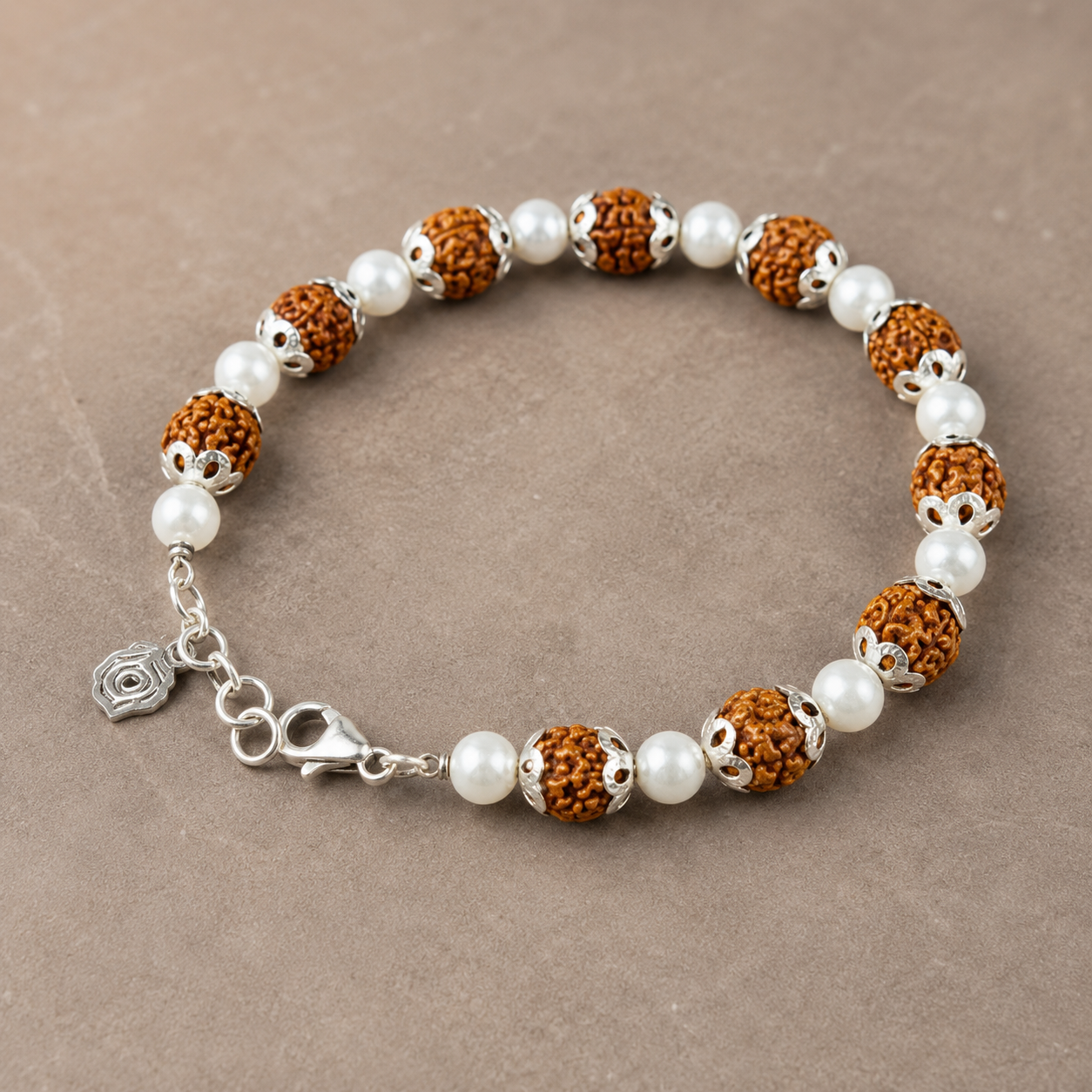 Silver rudraksha pearl bracelet with silver capping displayed flat