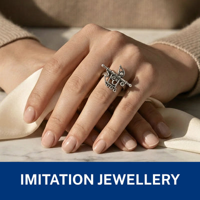 ornate silver-toned ring with a decorative motif.