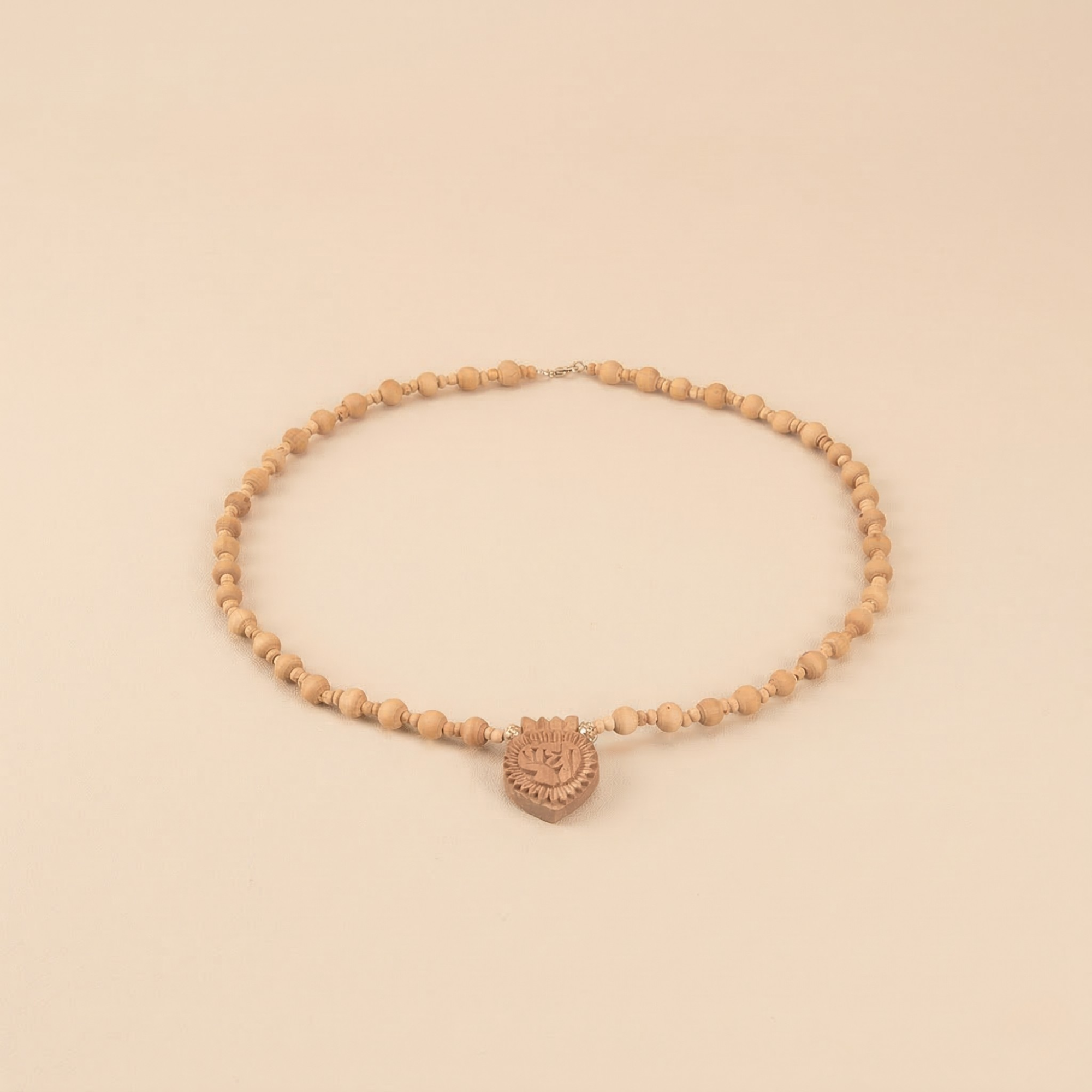 silver Tulsi bead necklace featuring a carved Radha name pendant