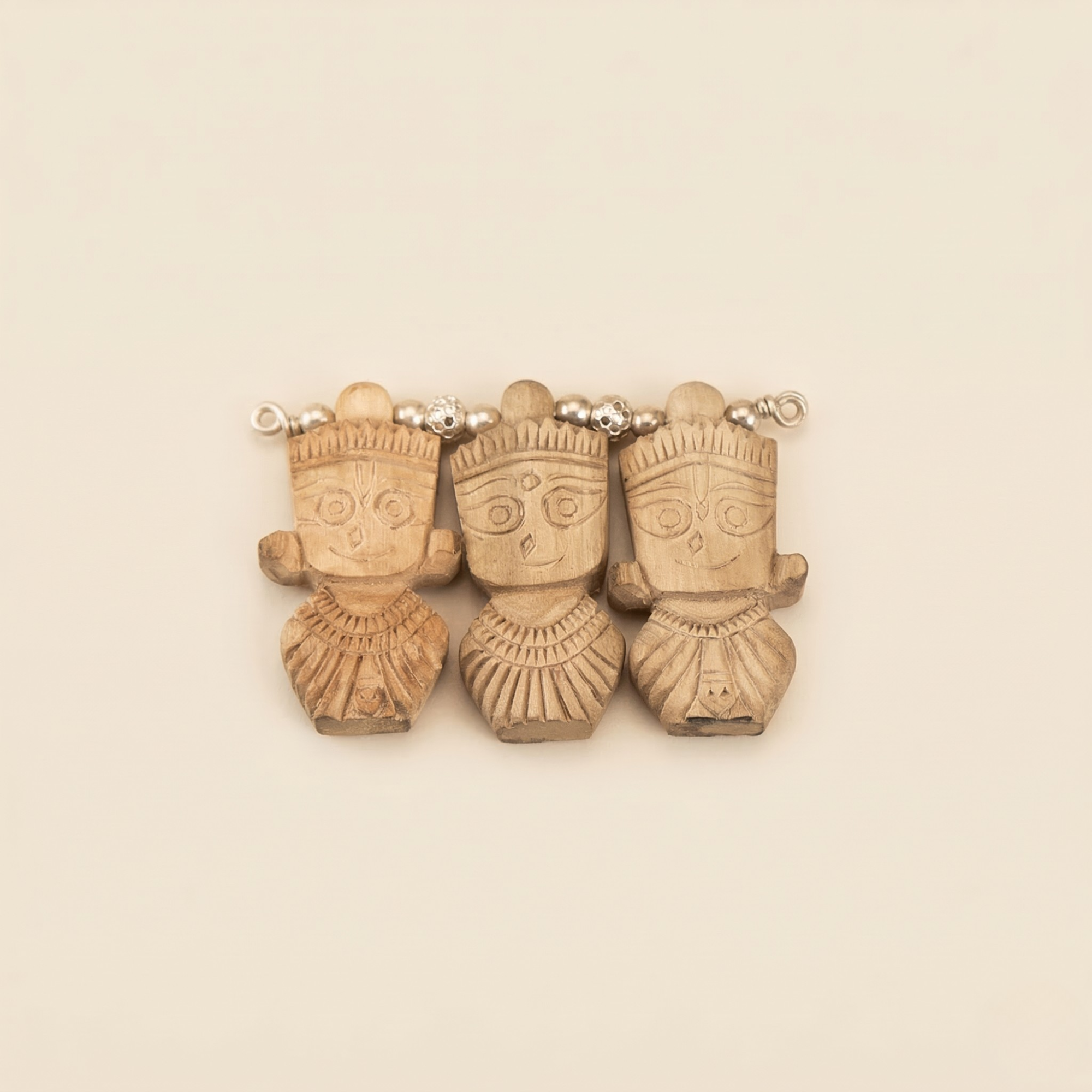silver pendant featuring authentic Tulsi wood carved into Jagannath, Balbhadra, and Subhadra
