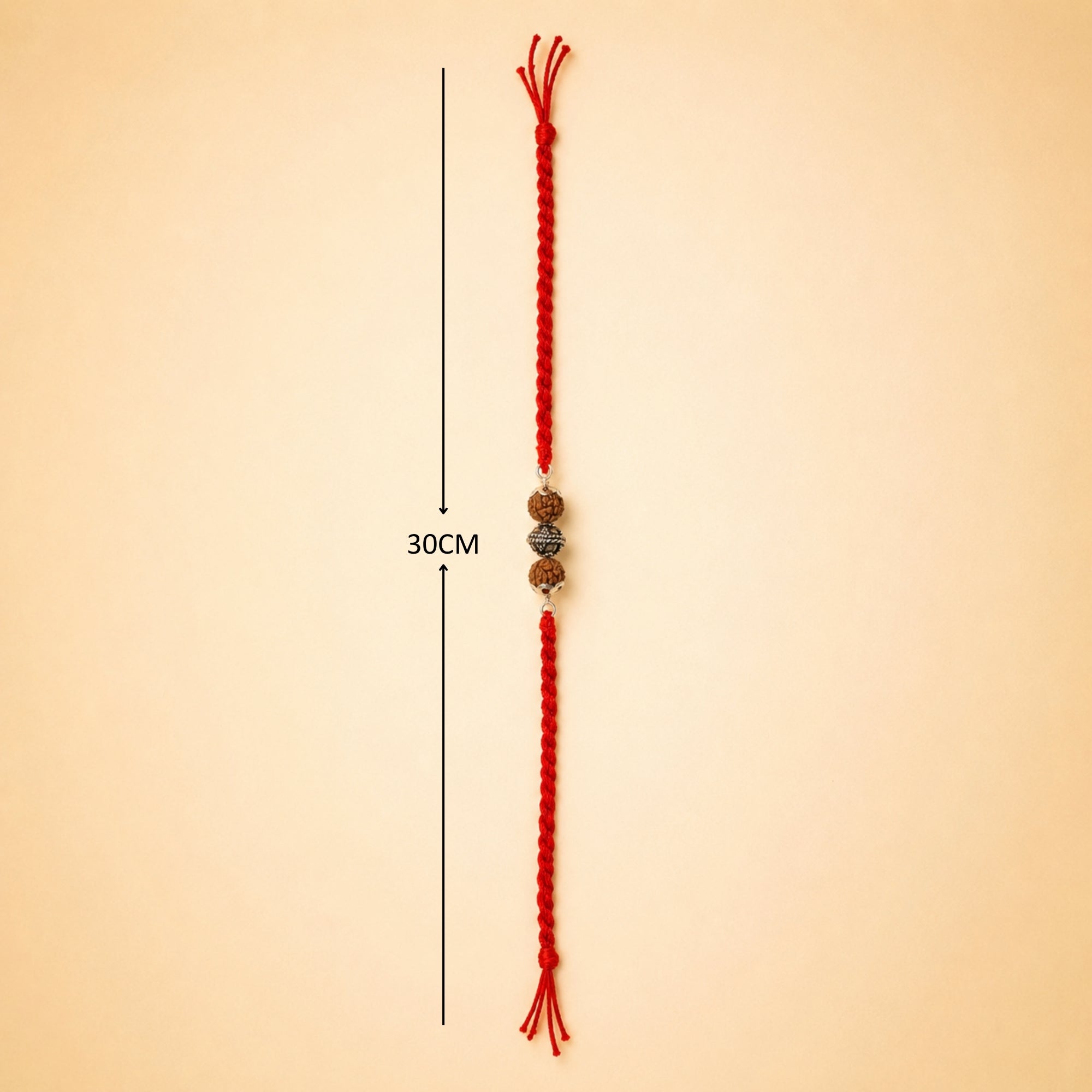 Full length layout showing red thread length and dimensions of silver Rudraksha rakhi