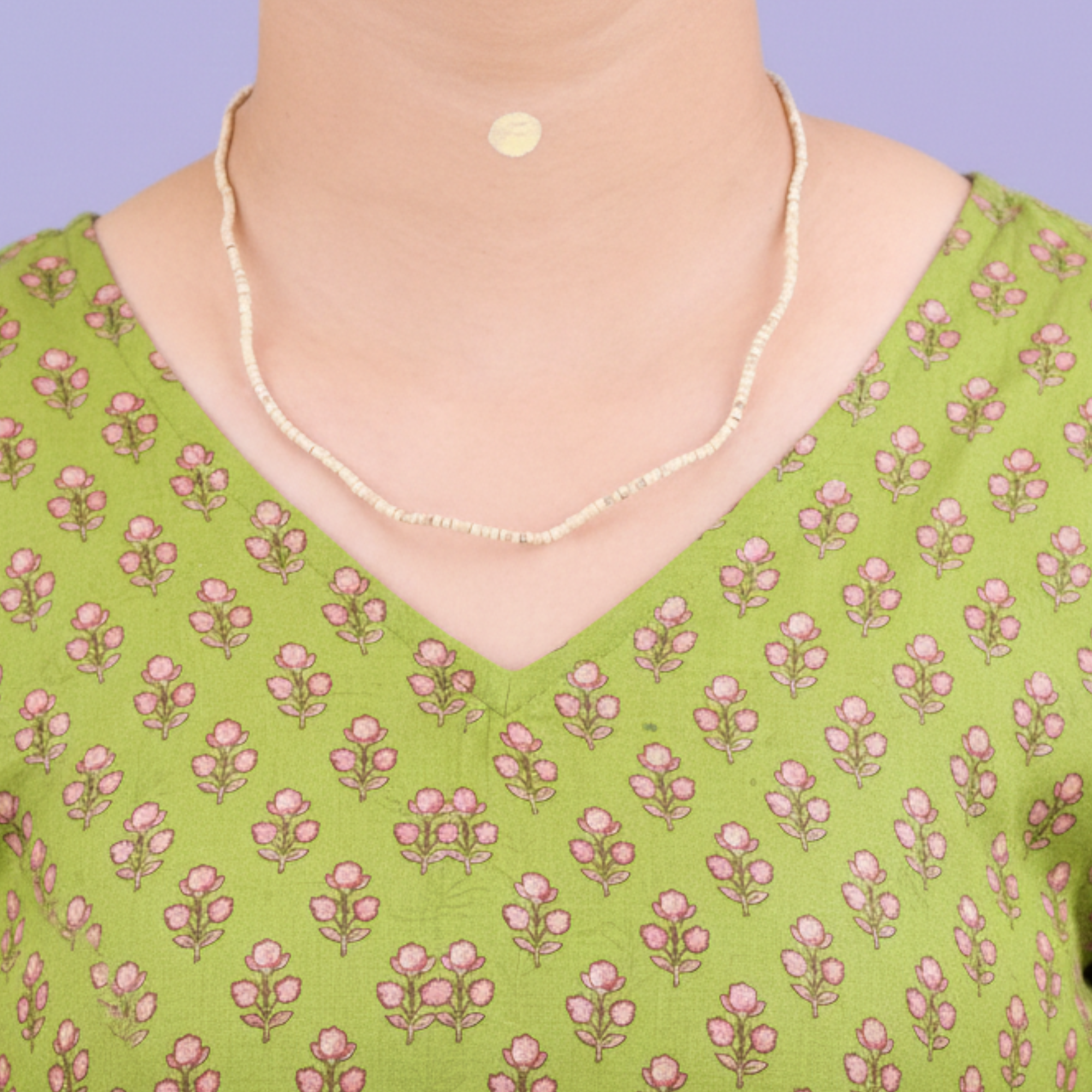 Woman wearing a delicate certified Tulsi kanthi mala with natural small beads