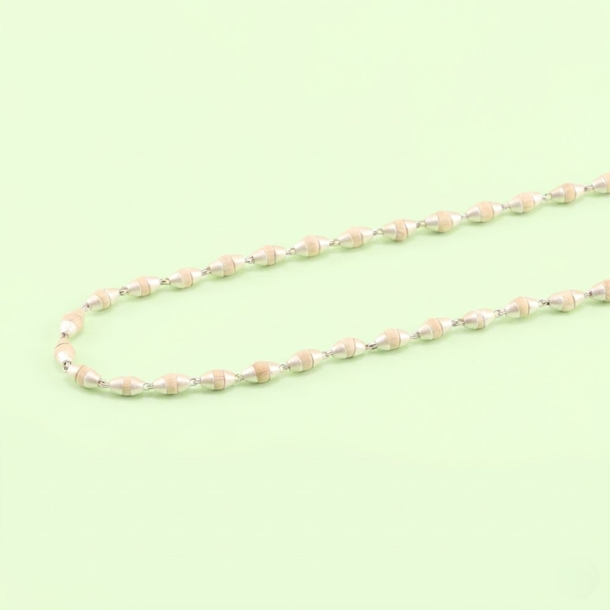 silver Tulsi bead necklace featuring small wood beads with silver capping