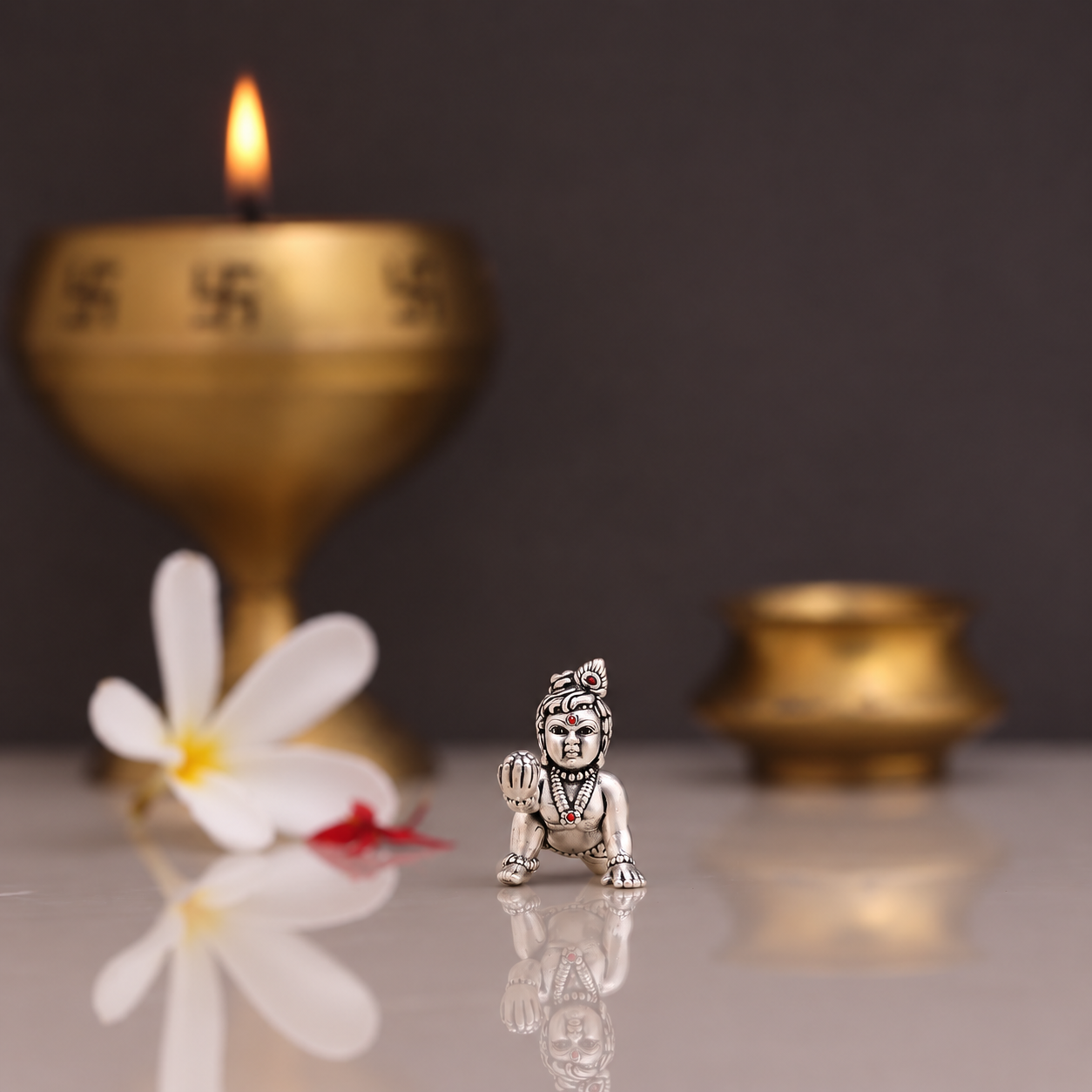 pure Small silver Laddu Gopal idol holding a laddu