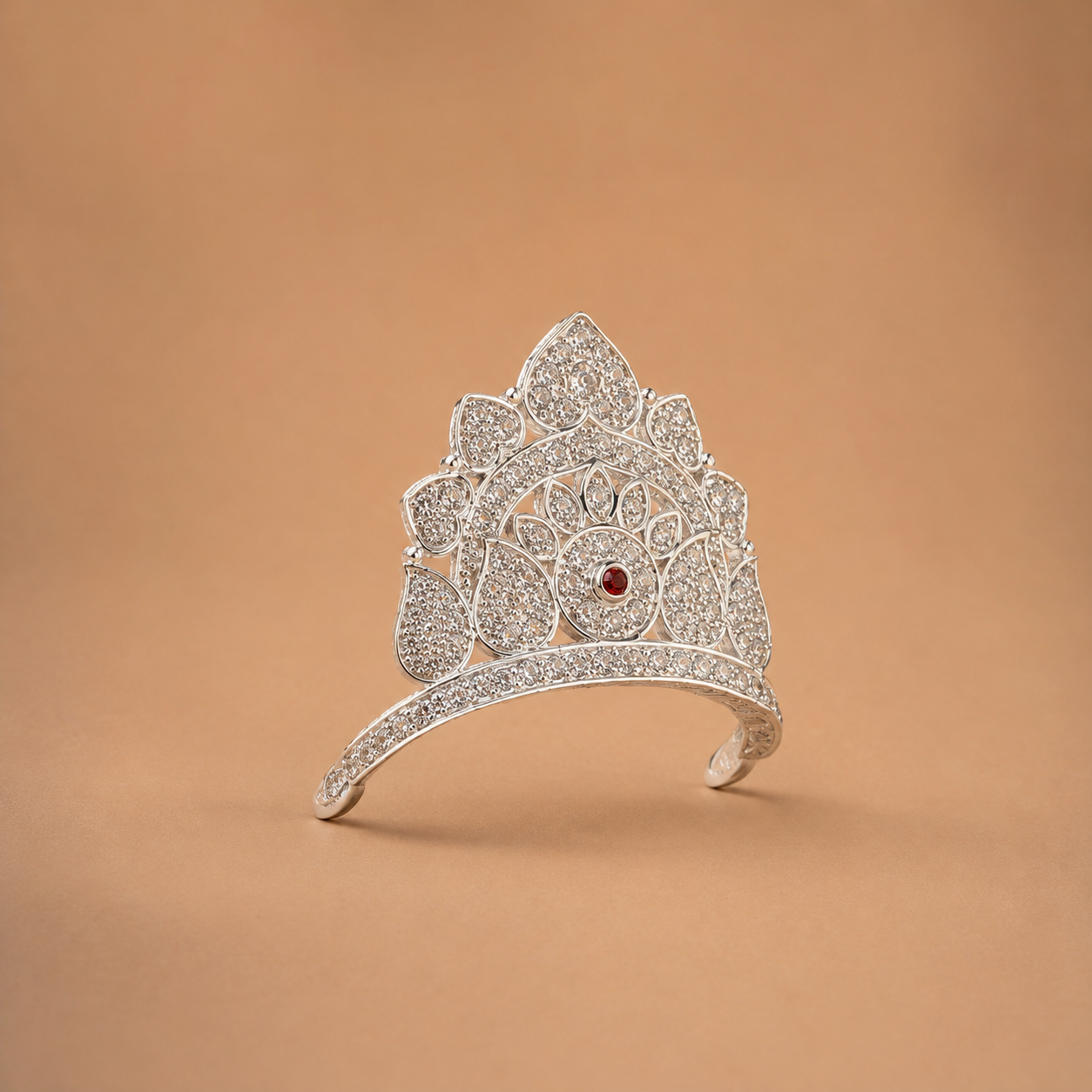 Side profile view of sterling silver mukut for Laddu Gopal on neutral background