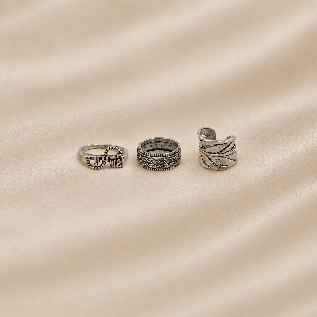 Three oxidised metal statement rings with traditional-inspired engraved designs
