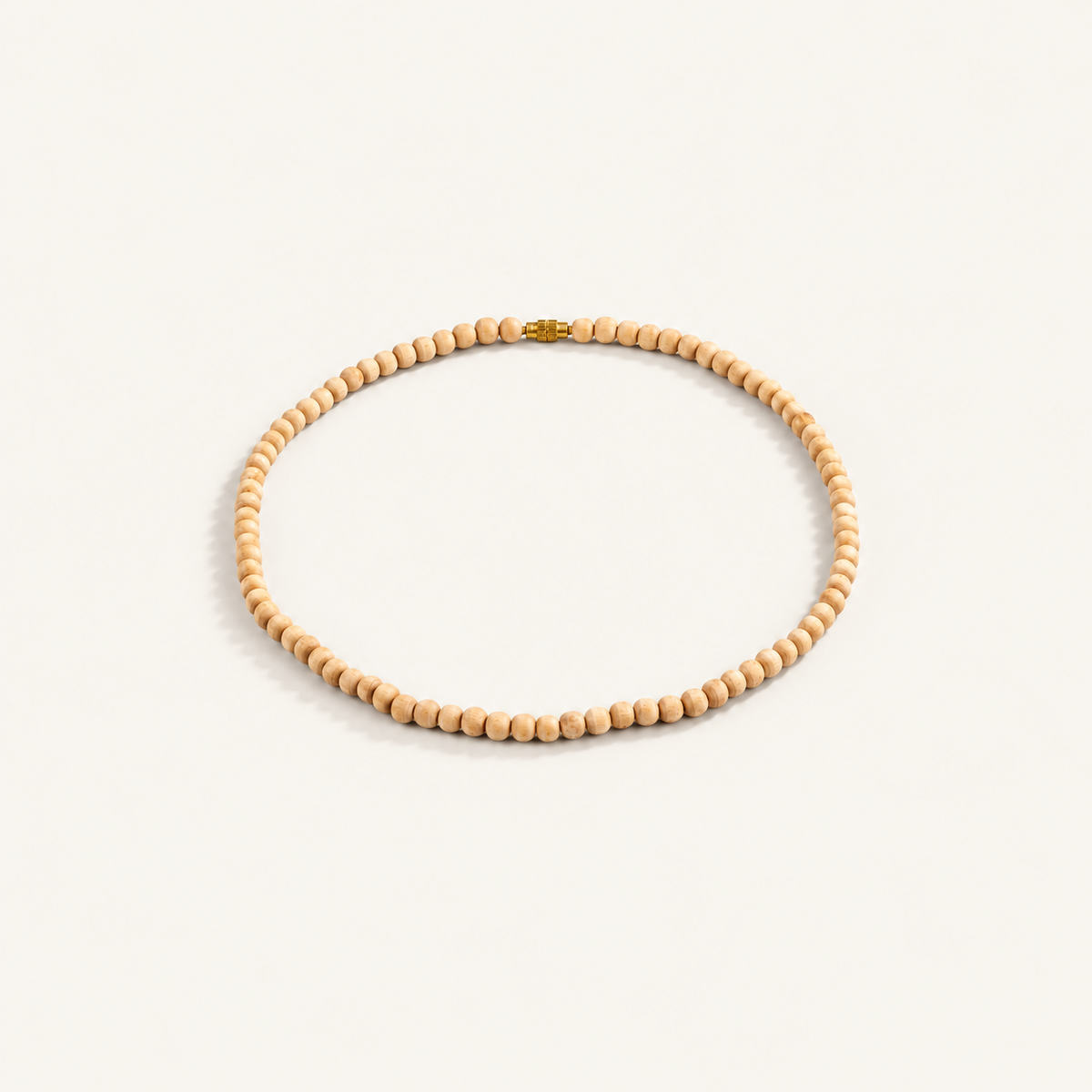 Light brown Tulsi bead mala arranged in a circle with a gold-colored screw clasp on an off-white background.