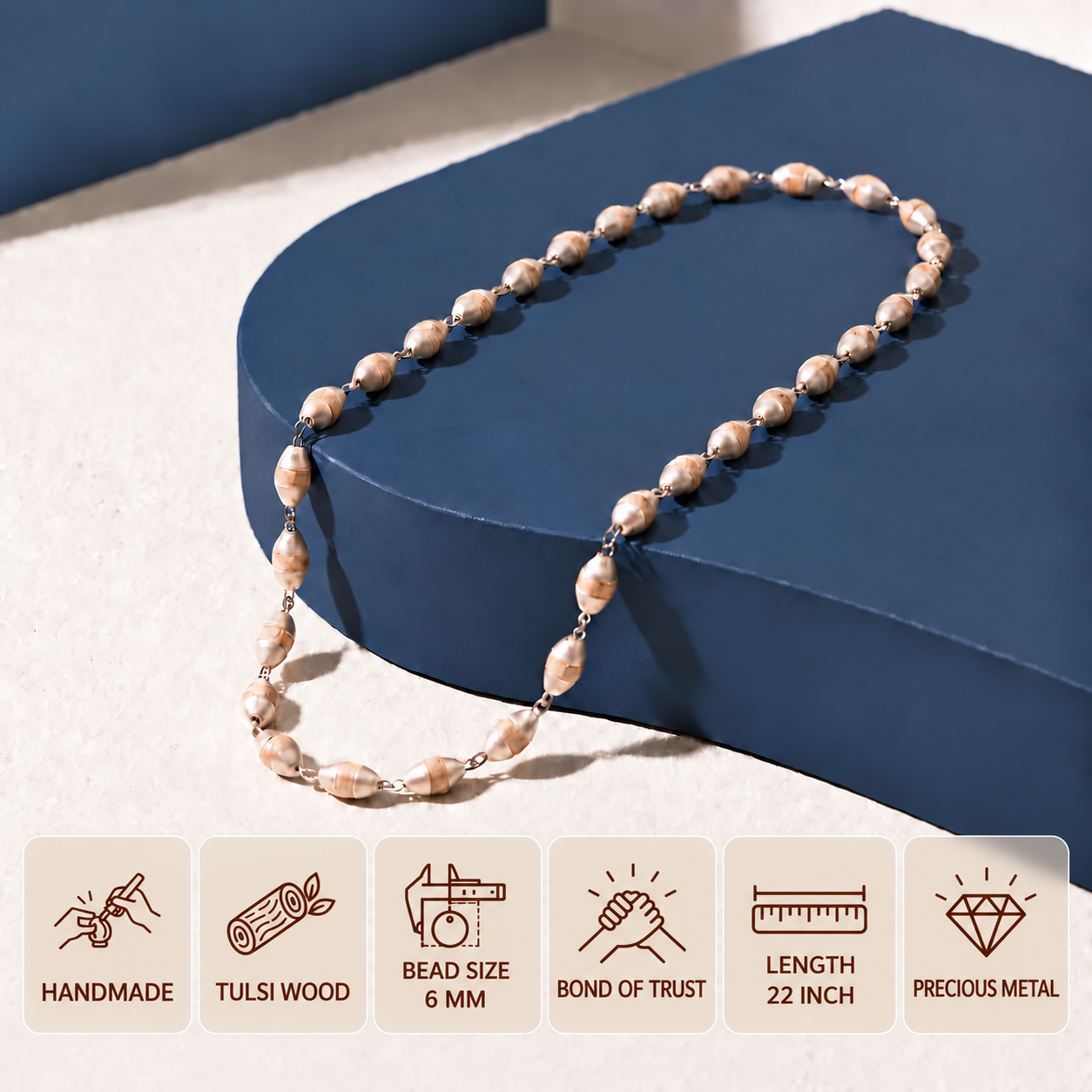 Tulsi bead mala with silver fittings displayed on a navy blue platform, with 6 mm bead size and 22 inch length shown.