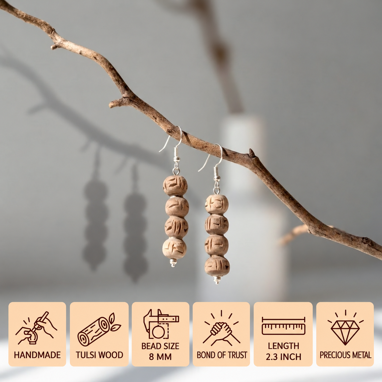 Pair of Tulsi wood bead earrings hanging from a branch, with 8 mm beads and a 2.3 inch length.