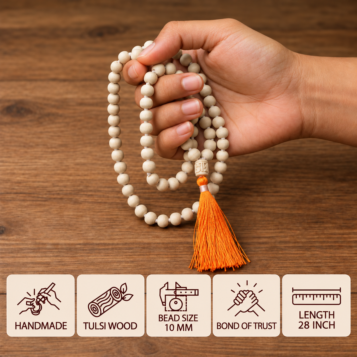 A hand holding a Tulsi japa mala with round beads and an orange tassel, with feature cards showing 10 mm bead size and 28 inch length.