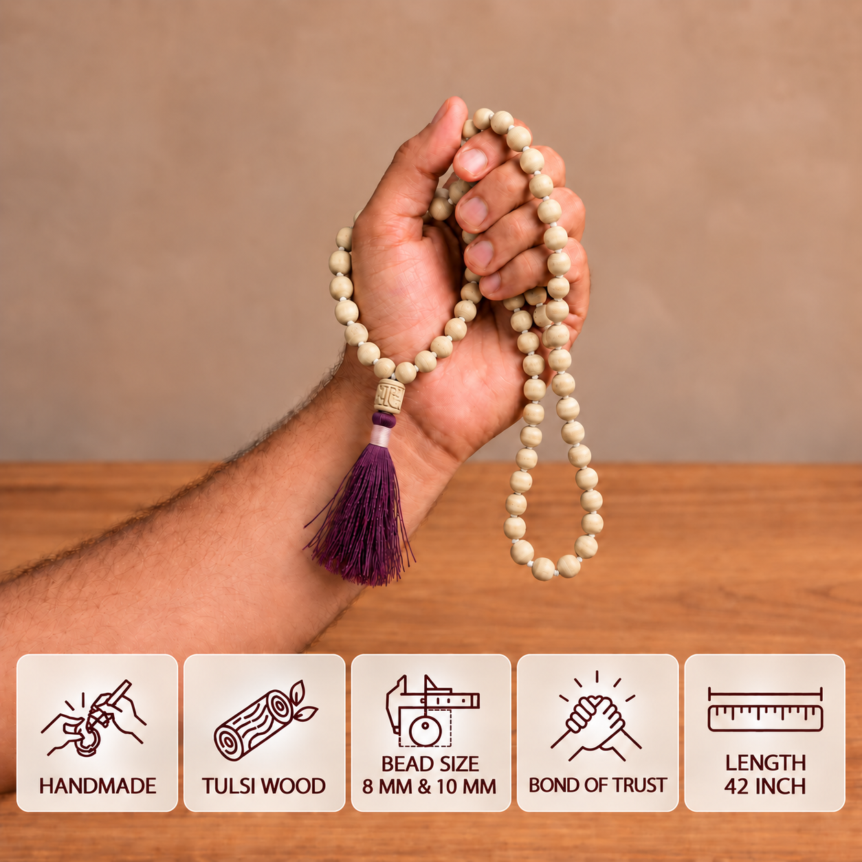 Tulsi japa mala with cream wooden beads and a purple tassel held in a hand, with feature cards showing bead sizes and 42-inch length.