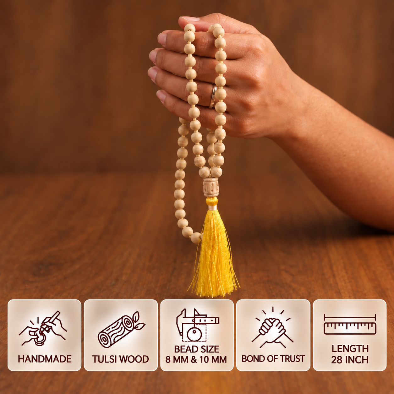 Hand holding a Tulsi japa mala with a yellow tassel, with feature cards showing 8 mm and 10 mm bead sizes and 28 inch length.