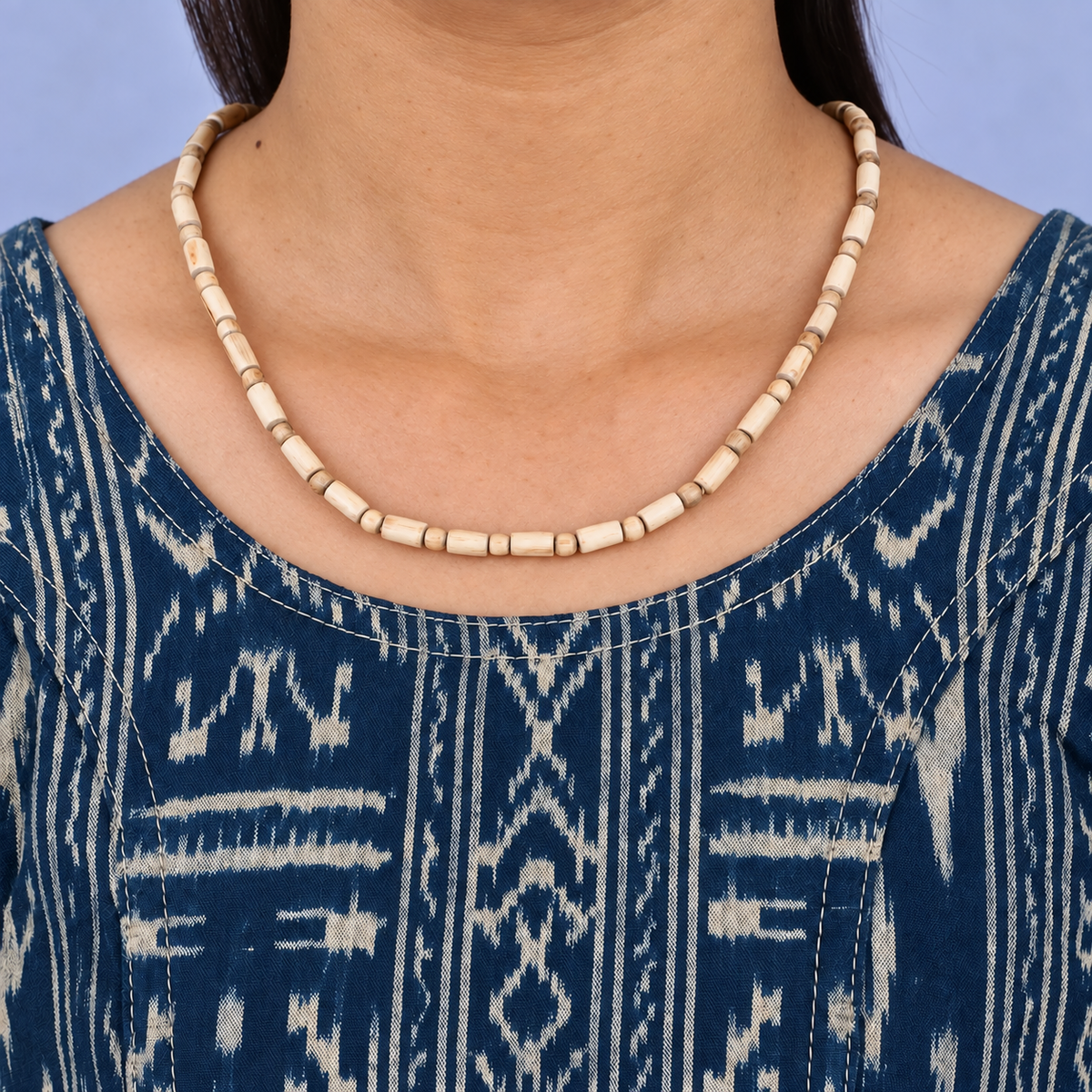 Tulsi kanthi mala with barrel-shaped wooden beads and round spacers worn with a blue printed kurta.