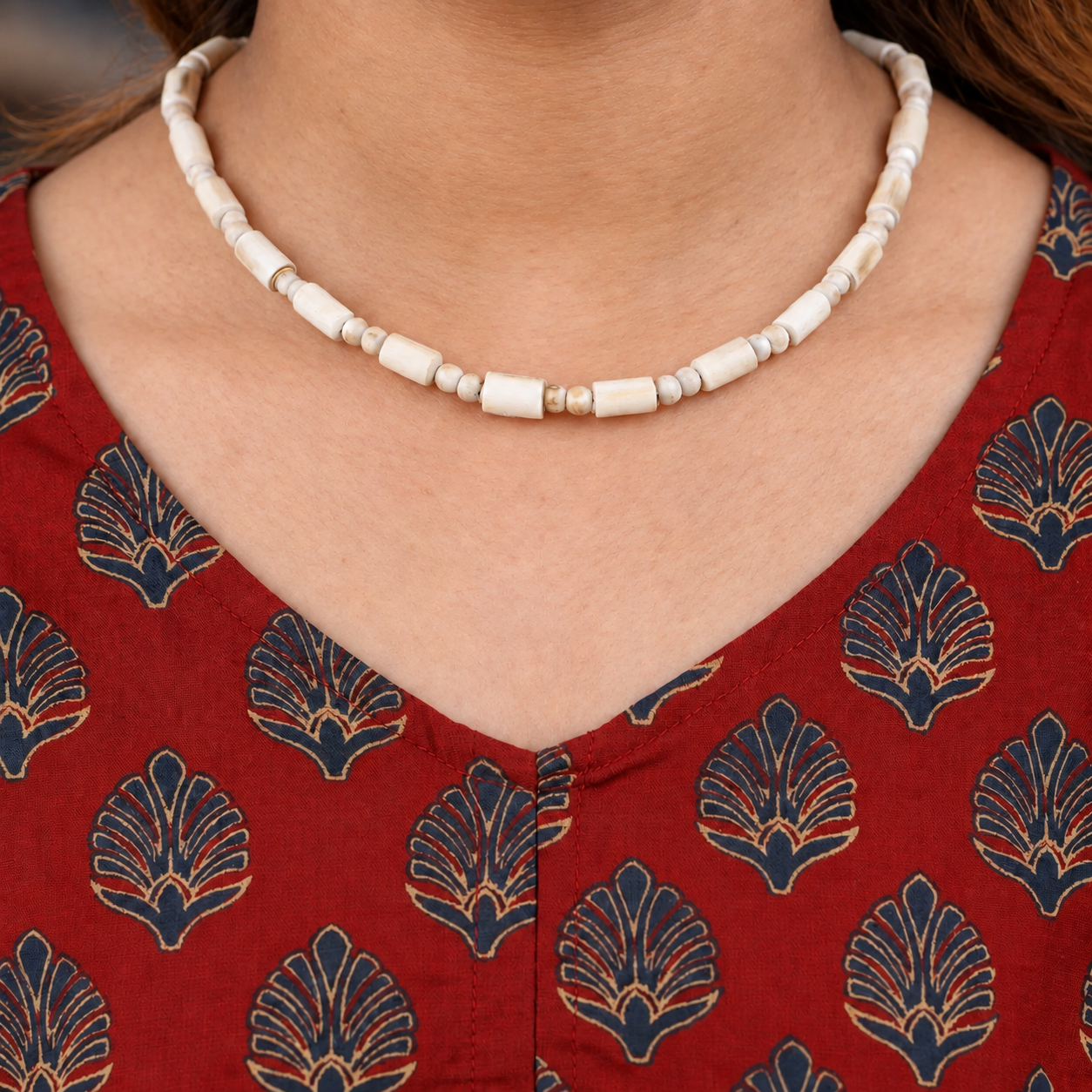 Tulsi kanthi mala with barrel-shaped wooden beads and paired round spacers worn with a red printed kurta.