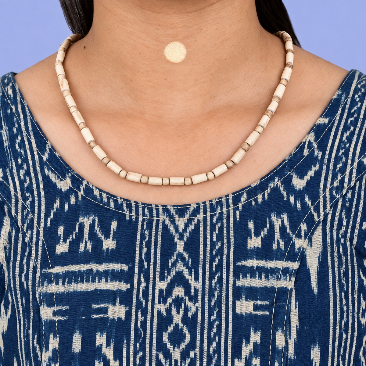 Tulsi kanthi mala with cylindrical wooden beads alternating with small round spacers, worn with a blue printed kurta.