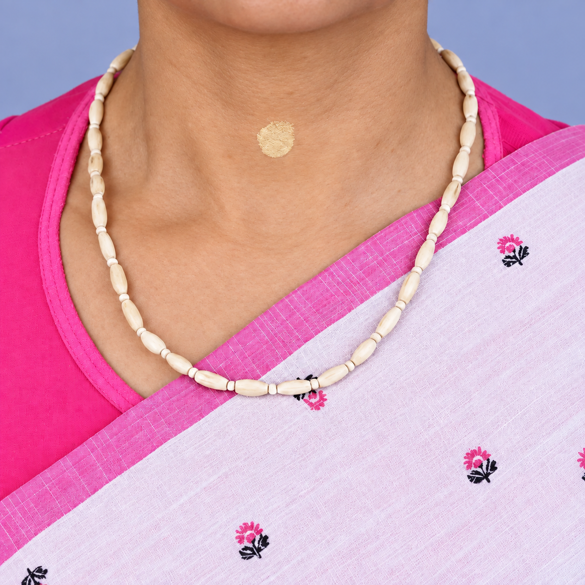 Tulsi kanthi mala with elongated wooden beads and small round spacers worn with a pink and white saree.